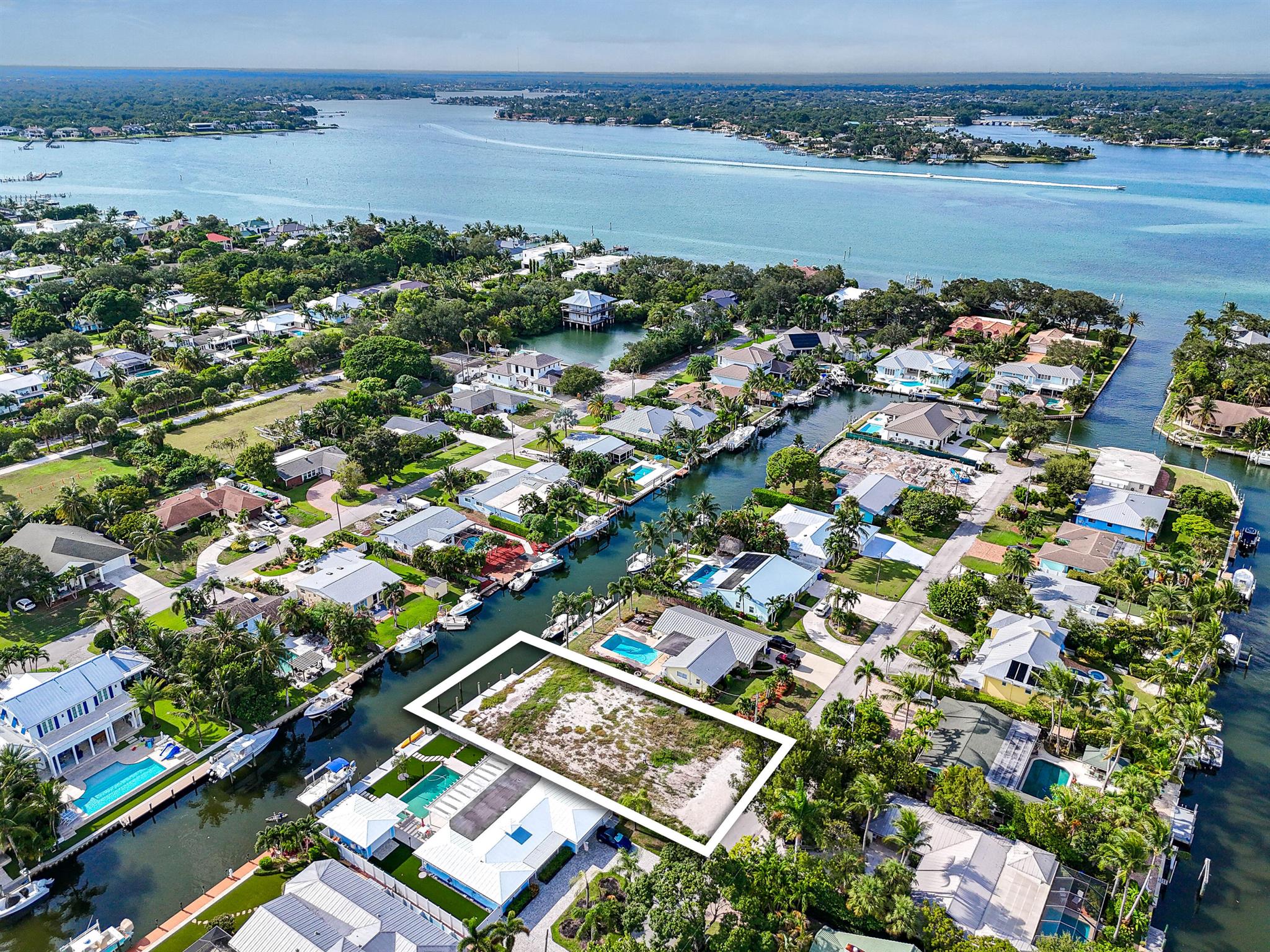 Incredible opportunity to build your dream waterfront home in the heart of Jupiter! This vacant lot offers ocean access on navigable water, a true boater's paradise. The property includes a private dock, with 2 new boat lifts (24k lb & 10K lb) providing quick and easy access to the Intracoastal Waterway and just minutes to the Jupiter Inlet and open ocean. Situated in a prime location close to world-class fishing, waterfront dining, shopping, and Jupiter's pristine beaches, this rare offering combines lifestyle and convenience. Don't miss your chance to create a custom waterfront retreat in one of the most desirable boating communities in South Florida!