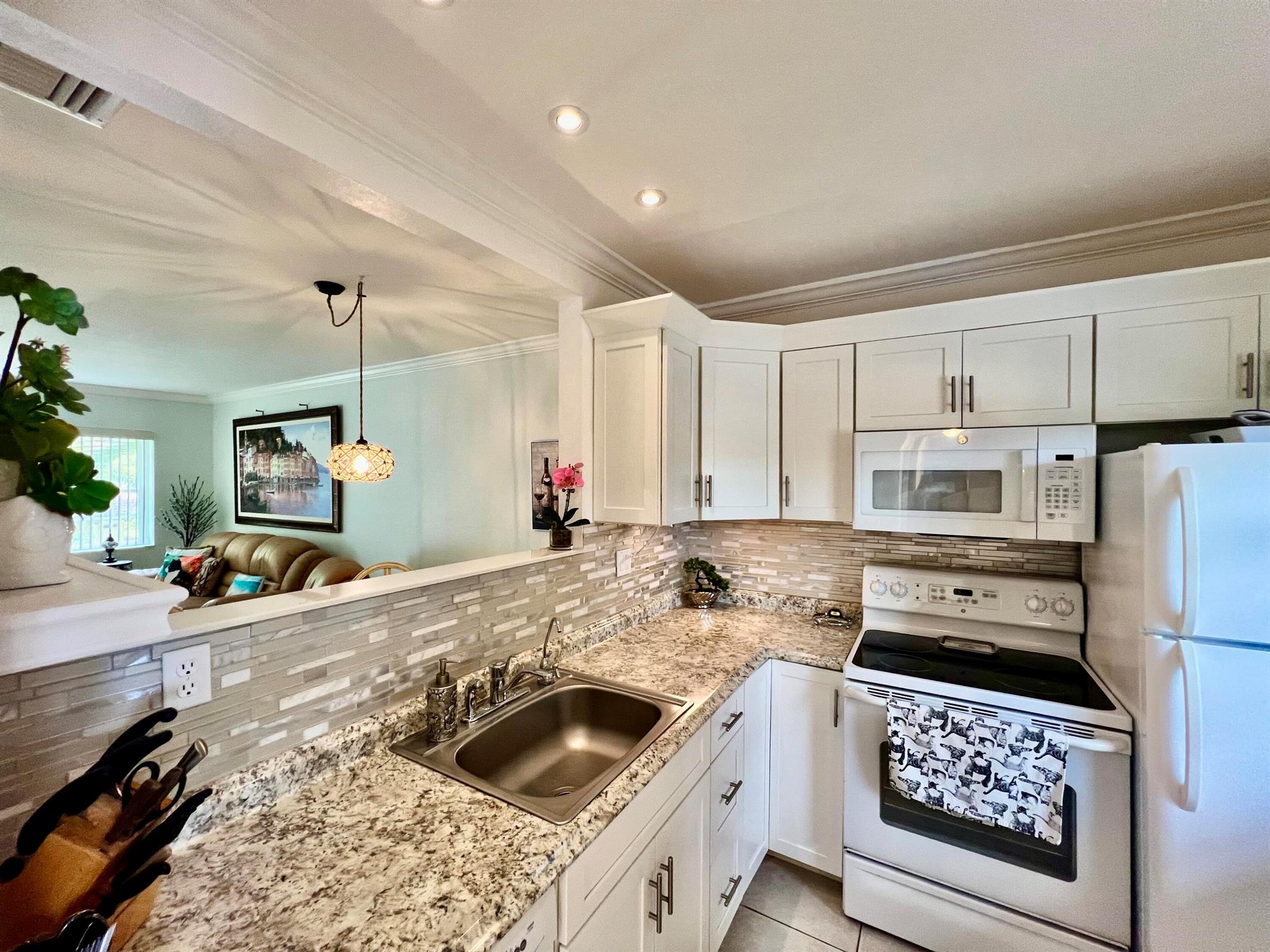 Beautiful 55+ Condo in Hawaiian Gardens Phase II! Stunning lake and pool views from this furnished, turnkey 1BR/1BA, 684 sq. ft. unit. Fully renovated kitchen, impact windows, AC 2019. Building has completed 50-year certification, new roof (2024), and reserves at 100%. Very low HOA with internet included. No special assessments! Great investment opportunity. Rental permitted with restrictions.