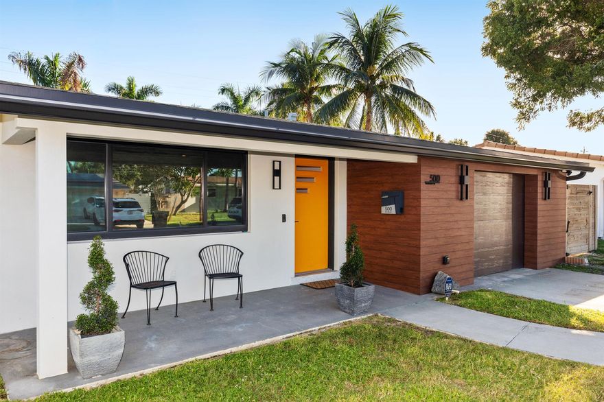NO EXPENSE SPARED IN THIS EXCEPTIONALLY DESIGNED MID-CENTURY GEM! Just minutes to Deerfield Beach and close to everything you need, this beautifully renovated home is unlike any you've seen in the area! Step inside to discover a light-filled, thoughtfully designed interior that blends mid-century charm with modern luxury. The custom chef's kitchen is a true showpiece: featuring tons of solid custom wood cabinetry, handmade Zia tile backsplash and bar wall, rose gold accents, a custom range hood, pot filler, Kohler fixtures, GE Cafe Series appliances, and quartz waterfall countertops. The kitchen flows seamlessly into a sunny dining area overlooking the large saltwater pool with Southern exposure! The covered patio (with electric blinds for sunsets!)is perfect for entertaining.