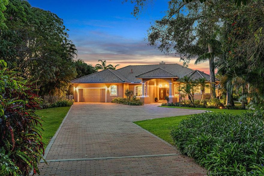 Extremely rare opportunity to own a 1.6 acre Riverfront parcel/home on the beautiful and scenic Loxahatchee River.  This 4BR/4Bth pool home was built in 1999 and sits on a huge lot with wonderful, serene river views, lush tropical landscaping and privacy galore!  A few interior features of this clean, well keep home include custom ceilings, formal living room with dual-sided fireplace, open kitchen with prep island overlooking the large family room, game room with wet-bar and spacious master suite with sitting area.  Exterior features include a pool w/ spa, cabana with bathroom & boat storage, basketball court, a fully equipped dock with 2 lifts & BOAT HOUSE (Extremely rare on the Lox. River and is grandfathered in) and over 100' of direct river frontage.