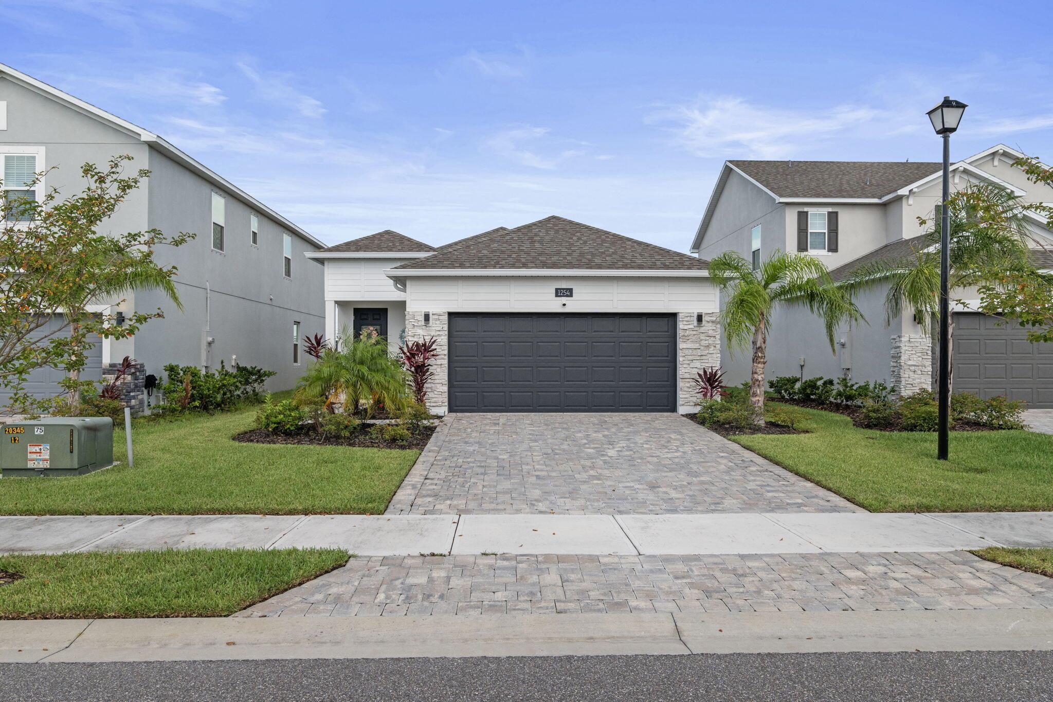 Newly Built in 2023, 3/2/2 Lake Front Home with many upgrades. Featuring SS Appliance Package, Quartz Counter Tops, Tile floors in living area, Apple Smart Home System to control everything from the AC, Light Switches, Oven to the Garage and more with voice activation. Newly installed Privacy Fence, Screened Patio with an extended paved open patio. Gardens at Waterstone is a highly desirable community with low monthly HOA fees & Pet Friendly. Amenities include a community pool, pickleball and playground. Close to Sunrise Elementary School and a few minutes' drive to shopping. All measurements have been estimated and should be verified.