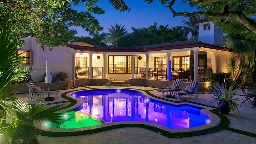 Palm Beach inspiration provides inviting charm & elegance to this professionally designed/decorated, FURNISHED tri-level residence. 2024 renovation after 1974 expansion. Villa Acacia occupies double 15,000sf tropically landscaped property. Walled & gated for privacy & security in gated/patrolled Idlewyld. Stunning retreat, fabulous entertaining flow. Generous formal living room features fireplace, wine cellar, wetbar, access to expansive covered terrace & Summer kitchen. Guest bath, Chef's kitchen & breakfast area, formal dining room & large TV/living room with beams, all accessing second terrace. Split bedroom plan affords privacy to substantial primary suite, private sitting area, spa-styled bath & custom closet. 2 large secondary bedroom suites. Incredible pool & lawn area must be seen!