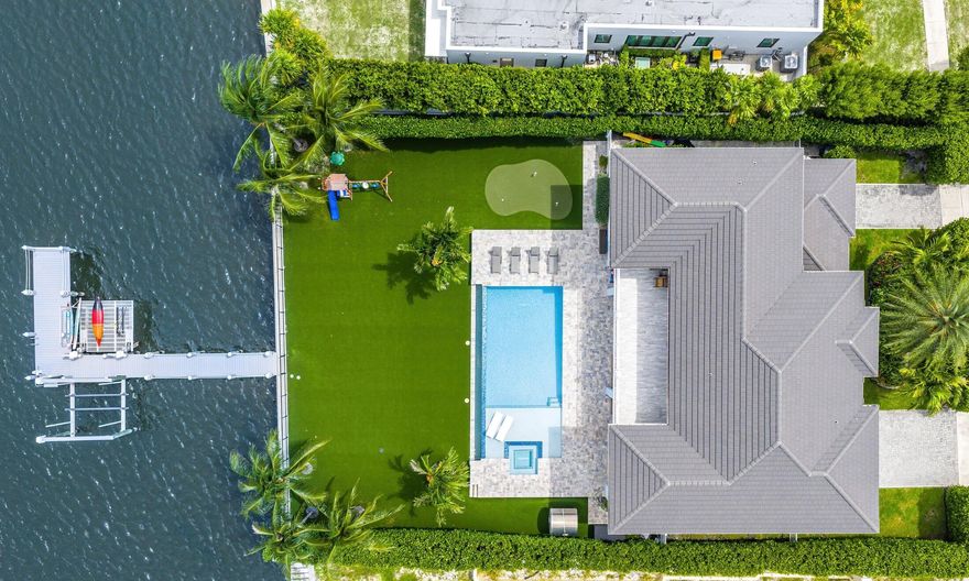 Welcome to this 2017 built, coastal contemporary waterfront estate located on the direct intracoastal in the heart of College Park! This timeless estate offers breathtaking intracoastal views and luxury finishes above and beyond what you expect to find. This trophy property spans two levels and features 5 Bedrooms + a Den/Office, 4.1 Bathrooms, nearly 5,000 Living SqFt, a three (3) car garage, and is nestled on a sizable, 15,000+ SqFt lot. Other notable features that this home offers, include natural gas, a Generac 24kW whole house generator, a fully operational elevator, an extended, composite wood dock, 20,000 lb boat lift, wave-runner lift, artificial turf backyard, and 15' high Clusia hedges for ultimate privacy and peace of mind. Enjoy your private, outdoor oasis with this resort-style backyard, which boasts an enormous 40' x 20' salt-chlorinated and heated pool, a relaxing sun-shelf, a spacious built-in jacuzzi, summer kitchen, and a three hole putting green all to yourself!

The main level features one guest bedroom, a den/office, full bathroom + powder room, and an open concept kitchen overlooking the family room, dining room, and an unmatched views of the intracoastal and backyard. The upstairs features the primary suite, three additional guest bedrooms, two full guest bathrooms, and a laundry room.

 The primary suite spans nearly 600 SqFt alone, which includes a palatial bathroom with dual vanities, freestanding bathtub, and an enormous, walk-in shower. In addition, the primary suite also offers a private, covered balcony overlooking the stunning backyard with views of South Palm Beach Island and even the Atlantic Ocean.

College Park is just a stone's throw away from the highly coveted Flager Drive and less than a 10 minute drive from the reimagined Downtown WPB, which features countless new restaurants, retail shops, eateries, and so much more. West Palm Beach has seen a surge of new development with luxury waterfront condo projects like South Flagler House by Related Ross, the 28-story Shorecrest, Olara residences, Nautilus 220, and the latest development, The Berkeley Palm Beach, all adding high-end living options to the skyline. 

This comes alongside a boom of restaurants, retail, and entertainment destinations downtown, including Eataly at CityPlace, Estiatorio Milos, Harry's Bar & Restaurant, a New York staple, cocktail lounge Mary Lou's, Tacos Del Cartel, and breakfast standouts like H&H Bagels in the nearby NORA Districtadding to the city's growing reputation as one of South Florida's most vibrant food and lifestyle hubs.