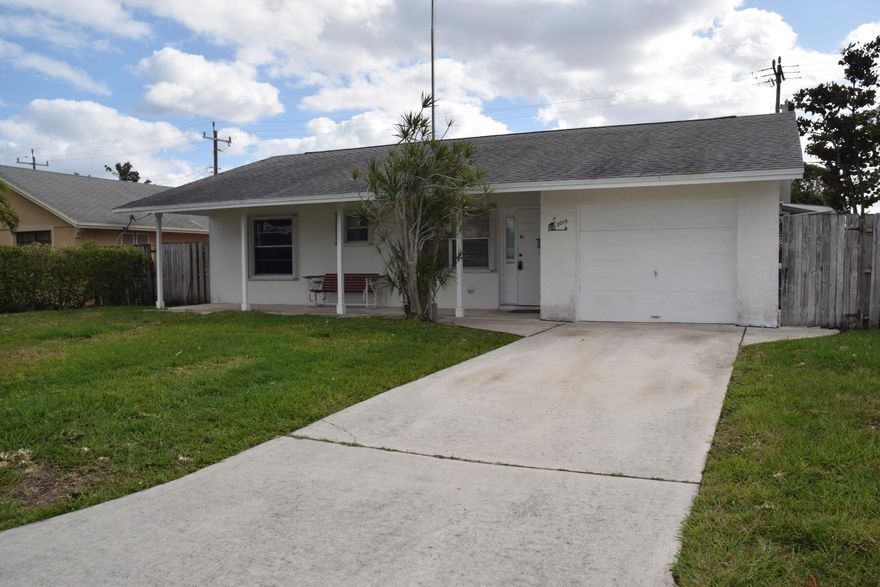 Great starter home or Investment Property.  Nice family oriented neighborhood close to shopping, schools and I-95.  2 bedroom/2 bath, new flooring and freshly painted.  Ready to move in!  Laundry room inside and a one car garage.  Huge fenced in backyard with a utility shed .  Pergola covered hot tub area in addition to a large tiled, covered porch.  Great family home or rental property.
