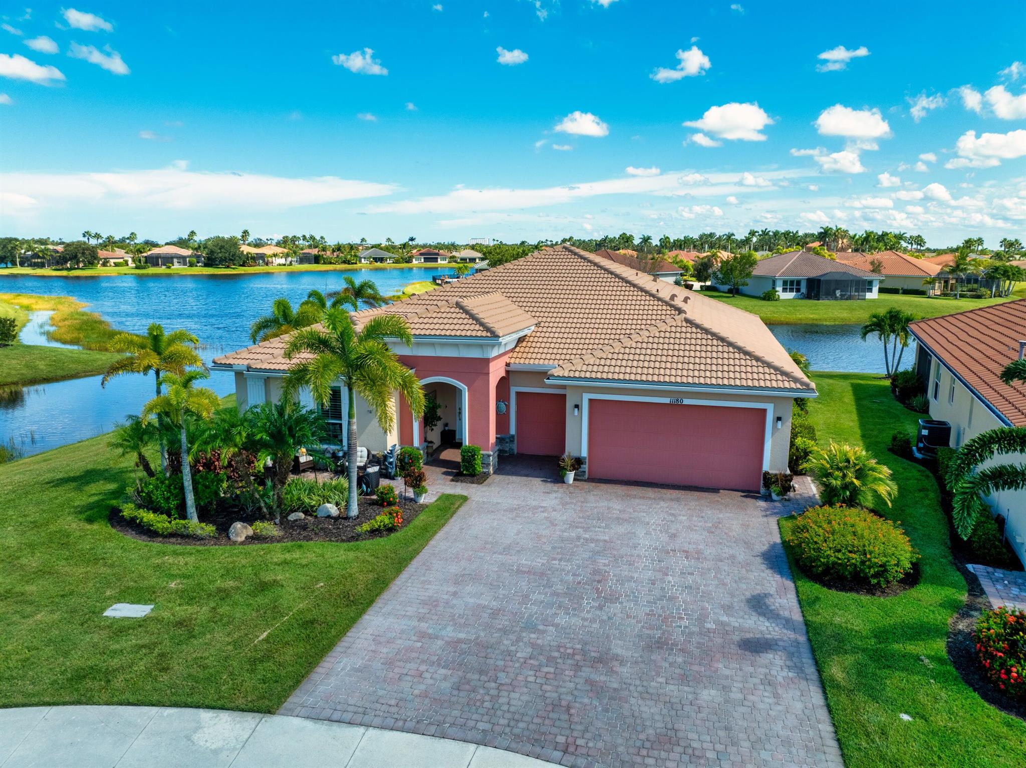 This stunning upgraded 3-bedroom, 2.5-bath home with office is set on a prime quiet cul-de-sac lot, offering over 2,400 sqft of beautifully living space. Throughout the home, you'll find crown molding, tray ceilings, upgraded lighting & fans plus built-in speakers in both the living room and lanai. The GARAGE is a standout with a 4-foot extension, golf cart garage, premium NewAge 24'' deep steel cabinets, shelving, HyLoft storage racks, & a floored attic with a elec pulley for safe access. Recent updates: new AC, dishwasher, & hot water heater, for long term use. Two guest bedrooms share a full bath, while a stylish half bath is perfect for guests. Enjoy open 180 lake views from your 24x54' travertine lanai complete with a 7x20.5' heated fountain saltwater POOL, gas firepit & BBQ. w b