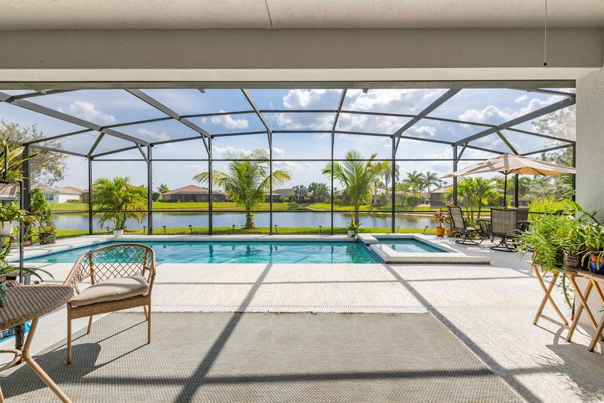 This LAKEFRONT POOL HOME sits on one of the BEST LOTS in Tradition offering real no filter SUNSET VIEWS, HEATED POOL & SPA, and a PRIVATE CUL-DE-SAC location on sought-after Vitalia Court, originally planned as MODEL ROW. Built in 2016, 3 BEDROOMS, PLUS a DEN, and 3 FULL BATHS and enjoy TWO PRIMARY SUITES on each wing of this home, CBS secured with IMPACT GLASS windows, and UPGRADED FLOORING throughout. The open layout highlights long lake views and effortless indoor-outdoor living. Enjoy a PRIVATE BRIDGE TO THE CLUBHOUSE and access to resort-style amenities. LOW INSURANCE & the HOA includes CABLE, INTERNET, ALARM, LAWN CARE, GYM, TENNIS, PICKLEBALL, POOL & MORE. Close to CLEVELAND CLINIC, TRADITION SQUARE, shopping, and 35 MINUTES TO THE BEACH. Located in a premier 55+ gated community