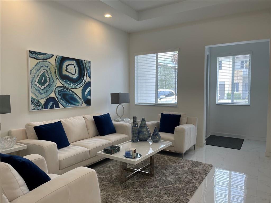 Beautiful corner townhome with a private walkway in a prime location! This 3 bedroom 2.5 bath townhouse was just built in 2019 and is move in ready! As you open the door to your new home you will notice the natural light and the high ceilings and doors. This spacious & bright modern built townhome features beautiful porcelain tile through out the first floor and a serene screen patio. The primary bedroom is very spacious and it features a balcony with a beautiful serene view & two walk-in closets. Home includes concrete block wall construction on the first and second floors! Community has a gated entry, cabana with 2 pools, fishing pier, & playground.Excellent Schools and shopping only a couple miles away.