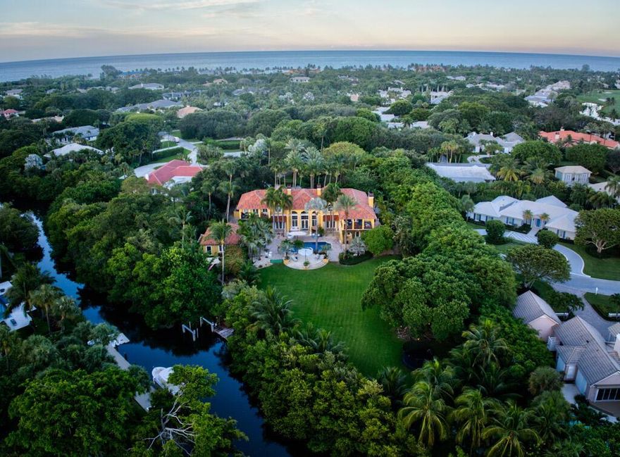 One of South Florida's most exclusive gated, the world renowned golf community of Seminole Landing. A Rare find, one of the few estate homes with a private gate in Seminole Landing, the hidden gem of North Palm Beach. No detail overlooked with extraordinary millwork throughout. Impact glass, whole house generator, guest cottage, dock situated on 2 acres. This exquisite custom home has direct access to Little Lake Worth and will not disappoint. Every inch of the property is covered with fountains throughout the gardens and all just a short walk to the private beach only Seminole Landing has to offer. Privacy, ocean and intracoastal water access.