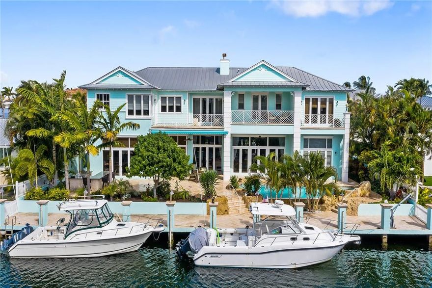 This 8,084 square foot coastal style home is less than one mile from the Hillsboro Inlet. This amazing 5 bedroom 6.5 bath home features top of the line chef's kitchen, bamboo wood floors, full house generator with automatic transfer switch, coral and cypress details throughout and a Pirates' of the Caribbean themed movie theater. Spacious master suite with beautiful water views featuring full his and hers bathrooms and large his and hers closets. Out back is a large tropical patio with summer kitchen, sparking pool with infinity edge and jacuzzi all with a desirable southern exposure. Concrete 100 foot dock with power and water for large boats and just minutes to the inlet this is the ideal location for boaters and fisherman a like.