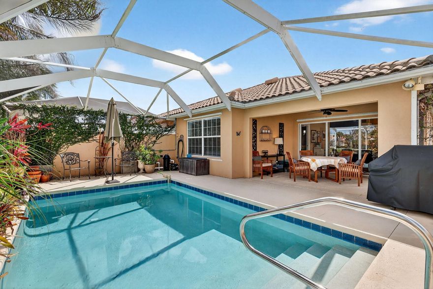 Immaculate villa offering a heated, screened-in pool with tranquil lake views. Over $30,000 in recent upgrades, including NEW air conditioner (2026) and water heater (2026), updated kitchen with convenient drawer pull-outs and added storage, S/S appliances, washer and dryer, updated ceiling fans and lighting, glass entry door, and new carpeting in the bedrooms. Add'l improvements include  pool heater (2022) and pool pump (2022). Located in a gated community with twenty-four-hour manned security and resort-style amenities, including two heated pools, tennis, pickleball, basketball, bocce, fitness center, clubhouse, and playground. HOA covers cable, internet, alarm monitoring, lawn care, manned gated security, and exterior painting. Built w/solid poured concrete walls and featuring a paver  brick driveway and walkway. The HOA is scheduled to paint the exterior a neutral color soon at no cost to the owner. This immaculate, move-in-ready villa will not last. Can be offered turn-key, excluding the owner's personal items.