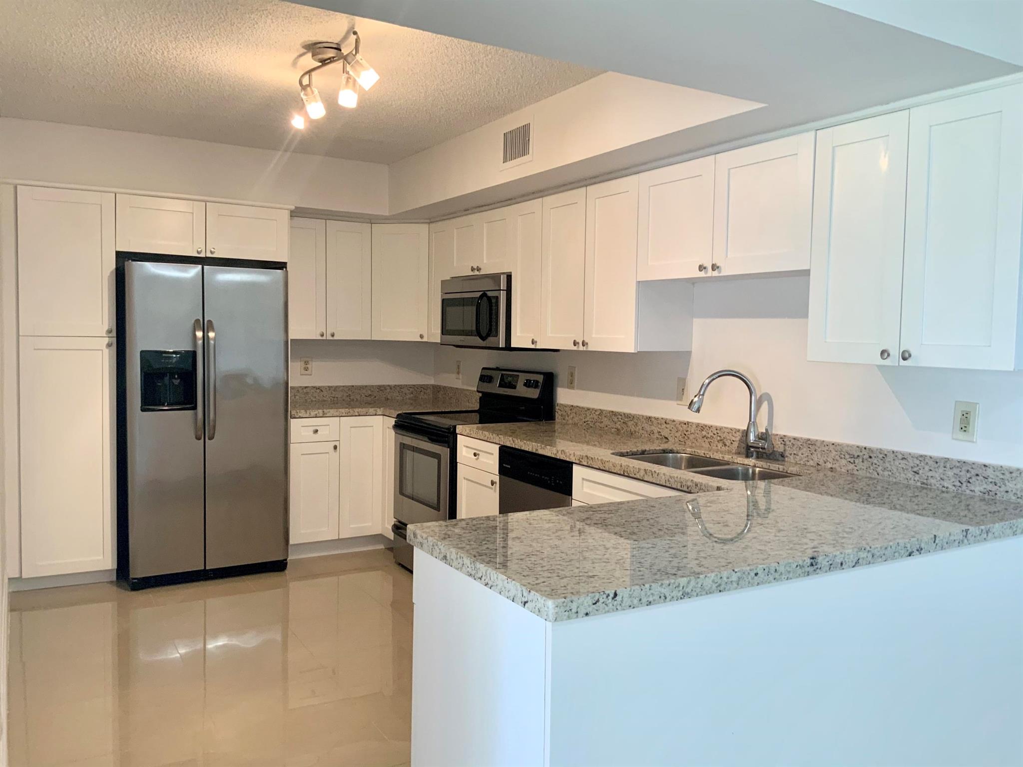 Boca Raton's best kept secret! Gorgeous updated 3/2 overlooking the lake in highly desirable Manned-Gated Windwood Community! Located East of 95, Approx 1 mile from the beach, amenities include huge Lake, tennis, basketball, 2 pools, dog park and more! water included. Won't last! Owner painting entire condo and replacing bedroom carpets and deep cleaning prior to new tenant!