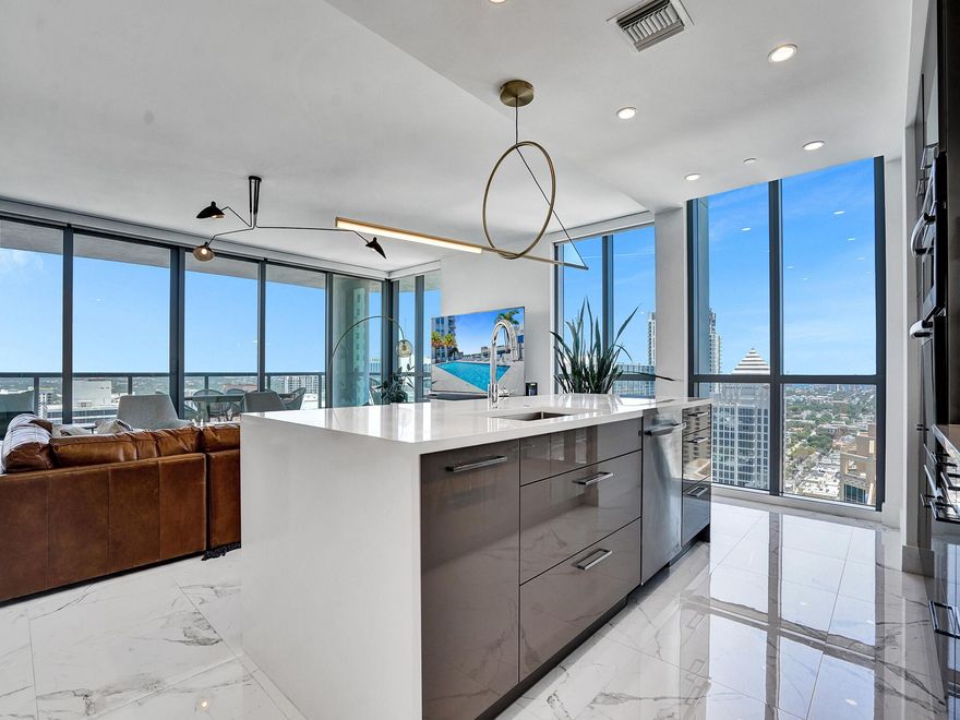 Fabulous sweeping panoramic backdrop of downtown Ft. Lauderdale's City Skyline with River & ocean views from its newest & tallest address, 100 Las Olas with wrap around, curved terrace. Walk to restaurants, shops, night life, grocers, theater & water taxi. From stunning sunrises & sunsets to sparkling city night lights, this highly desirable Model ''A''open floorplan with modern European cabinetry, top of the line appliances, waterfall island, sparkling white tile, Smart tech, remote solar blinds on all sliders & windows has it all! Third Bed is Office with Murphy Bed for versatility. Primary Bed has private balcony, spectacular views, huge walk-in closet seamless glass bath. 2 garage spots. Resort style living incl. pool, full gym, sundeck, grille, coffee room, party room & more.
