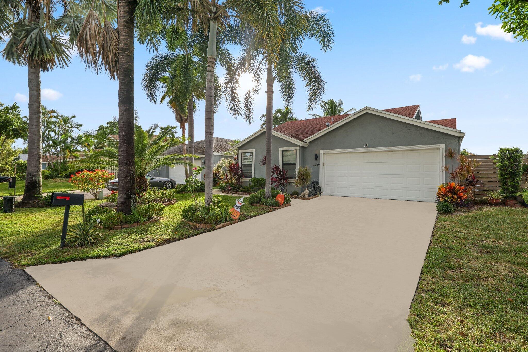 Welcome to Rainberry Lake, a beautiful gated waterfront community just one mile from Atlantic Avenue in Delray Beach. This neighborhood offers direct access to Lake Ida and Lake Eden for boating, fishing, kayaking, paddleboarding, and more, with a canal in your backyard connecting to Lake Ida and Lake Osborne along a 25 mile navigable waterway. Enjoy the South Florida lifestyle with your own private dock. This completely renovated home showcases modern design and quality craftsmanship with new hurricane impact windows and doors for security and style. The open layout is filled with natural light and features tile flooring throughout. The kitchen offers stunning waterfall countertops, custom white cabinetry