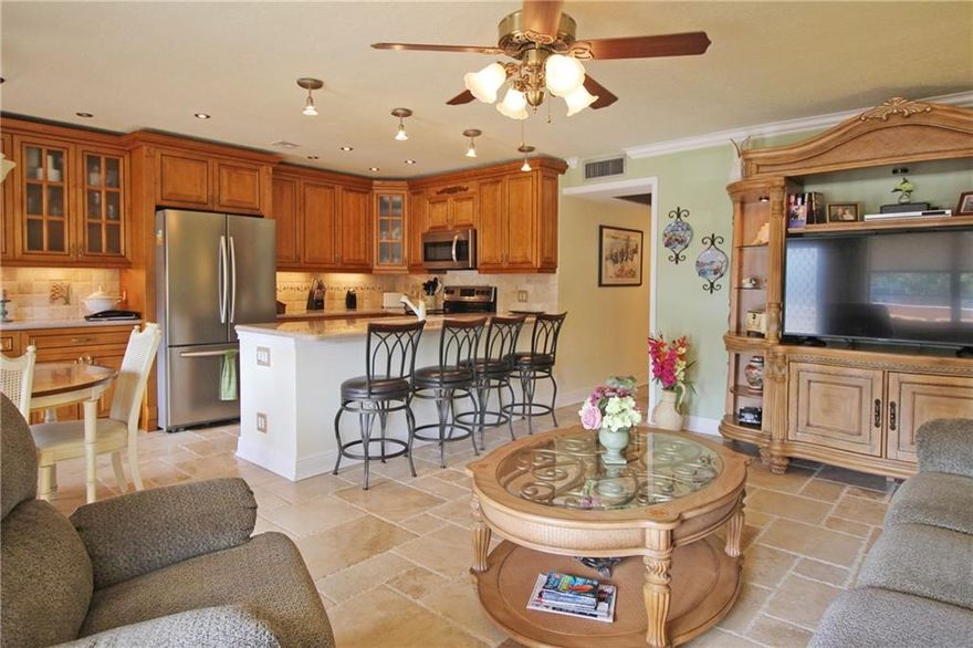 MOVE RIGHT IN!! THIS STUNNING TWO BEDROOM, TWO BATH HAS BEEN REDONE FROM TOP TO BOTTOM!! THE OPEN KITCHEN IS FABULOUS W/ WOOD CABINETS, GRANITE COUNTERS, STAINLESS STEEL APPLIANCES AND UNDER COUNTER LIGHTING!! A GORGEOUS ITALIAN STONE FLOOR WILL TAKE YOUR BREATH AWAY! CROWN MOLDING THRU-OUT!! BOTH BATHROOMS FEATURE LOVELY TILED WALK IN SHOWERS, SEAMLESS GLASS SHOWER DOORS AND GRANITE COUNTERS! PARTIALLY FURNISHED! KNOCKDOWN ON CEILINGS! WALK TO THE PLAZA AND JUST STEPS TO THE POOL!! CENTURY VILLAGE EAST IS A GATED COMMUNITY WITH FREE TRANSPORTATION INSIDE AND OUT!! THEIR LAVISH CLUBHOUSE FEATURES CLASSES, CLUBS, FREE MOVIES, BROADWAY SHOWS & STATE OF THE ART GYM!!10 MINUTES TO BEACH! CLOSE TO SHOPPING, MAJOR HWYS AND GREAT RESTAURANTS!  ASSOC. CLAIMS 55+.