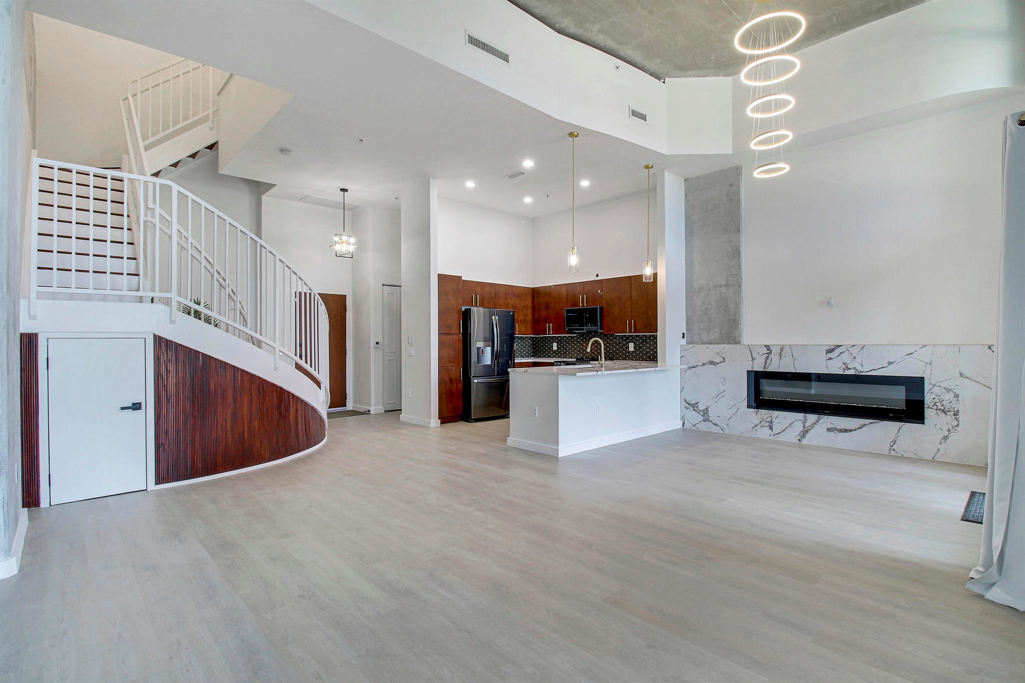 Welcome to your own piece of paradise, with amazing water views! This stunning fully renovated townhouse allows you to enjoy the space, and comfort of a townhome, while giving you the luxury, and convenience of condo living! Enjoy the best of both worlds! There are only 8 unique layout townhomes in the entire building, making this unit a super rare find!! Separate private back entrance + porch allows for easy access to take serene walks by the lake. The soaring 16 foot ceilings with gorgeous, custom chandeliers, and all of the expensive floor to ceiling windows for extra natural lighting, adds to the luxury feeling of this unit. No expense has been spared featuring so many custom built-ins, the first floor has a newly built fireplace, walk-in closets + pantry for easy storage,