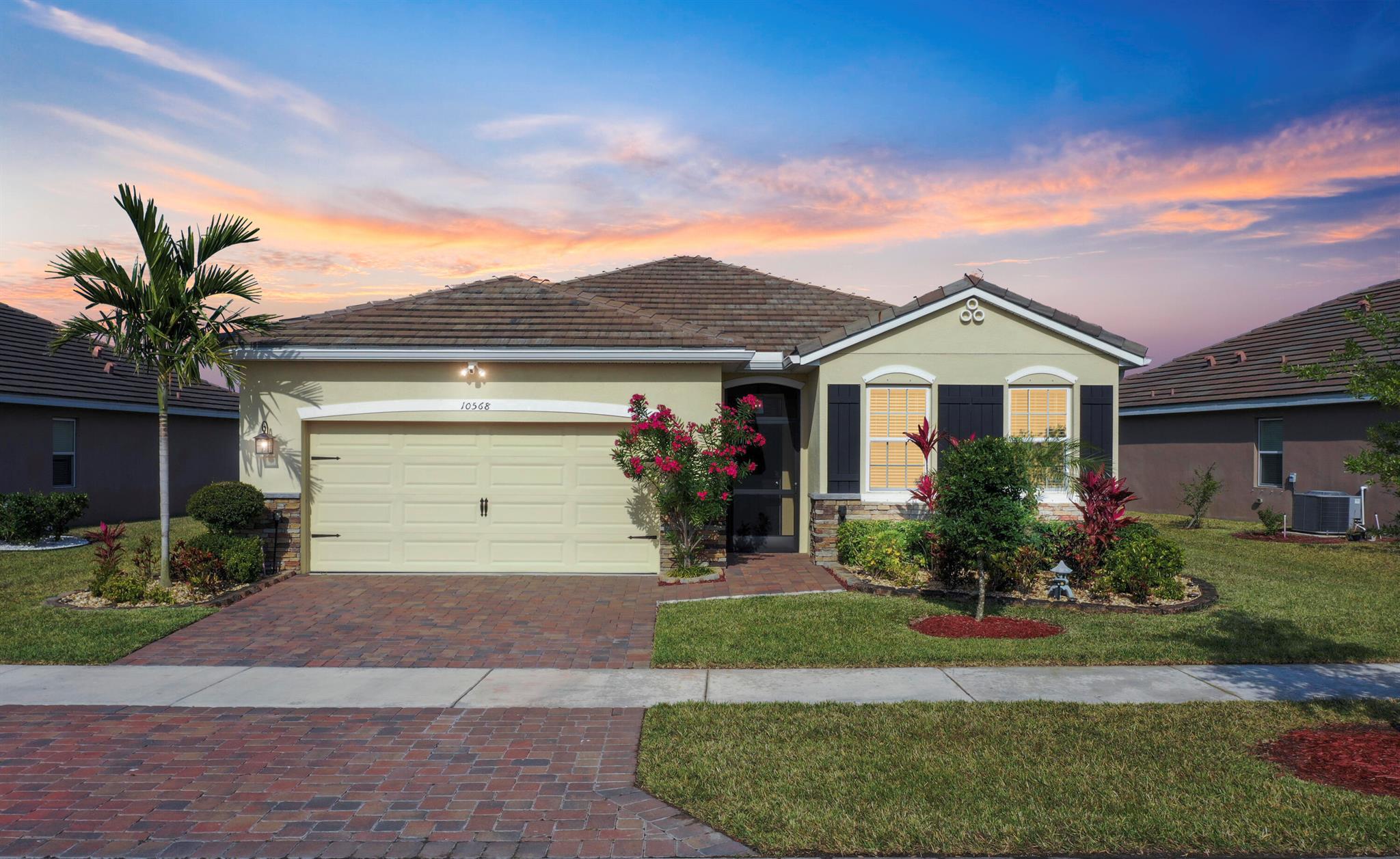 Come enjoy the meticulously maintained 4 BR, 2 Bath home close to everything in Tradition. The neutral-colored tile in the kitchen and living areas & carpet in the BR's will go with most any decorating palette. The kitchen has white cabinets, SS appliances, granite and a large walk-in pantry. The open concept living area encourages entertaining and the 4 Bedrooms allow for 'away' space as well. The large Primary BR has two walk-in closets and is attached to the bathroom with two sinks (with plenty of area between them) and a tiled shower. The 2nd Bathroom is flanked by two linen closets for great storage. The Lanai has ample space for a seating area plus a table & chairs. The Preserve, part of the Estates of Tradition, has a community pool, sidewalks & a beautiful, gated entrance.
