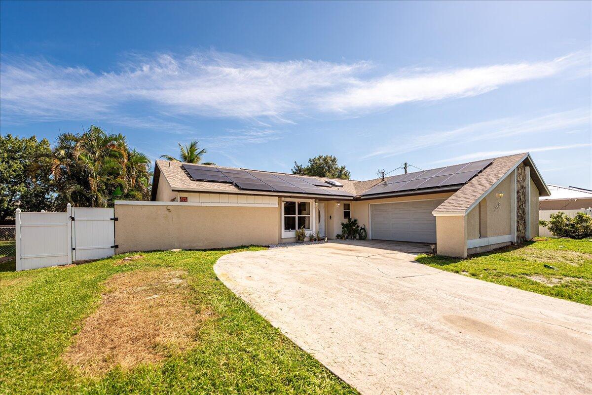 This beautifully finished 4-bedroom, 2-bath pool home offers the perfect blend of comfort, functionality, and location. The open floorplan is ideal for modern living, featuring a well-appointed kitchen with granite countertops, quality cabinetry, and newer appliances. A separate in-law suite provides flexibility for guests, extended family, or rental income potential. Enjoy peace of mind with a new roof and newer AC, and make the most of Florida living in your private backyard oasis with a sparkling pool and fully fenced yard. Conveniently located near the shopping, dining, and entertainment options of St. Lucie West, this home is move-in ready and packed with value. Don't miss it!