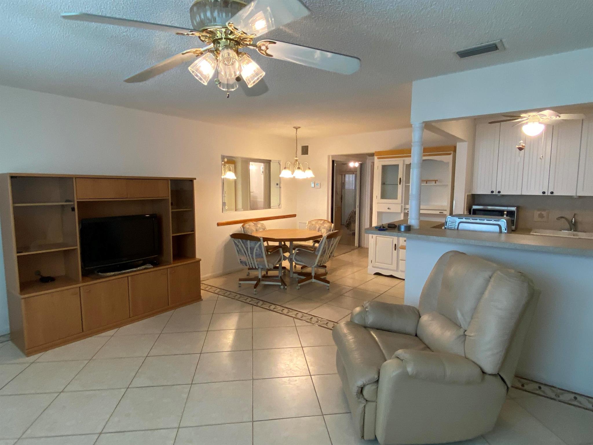 Experience everyday beauty in this turnkey, ground-floor condo, available fully furnished or unfurnished. The condo features tile throughout, central A/C, and in-unit washer and dryer. Enjoy a spacious screened patio, perfect for dining and entertaining and a short stroll to the Intracoastal Waterway. Sterling Village offers a newly renovated clubhouse, a secure gated entrance, a pool, putting green, bocce, and pickleball courts, and diverse recreational areas, all ideally located near world-class shopping, dining, and entertainment