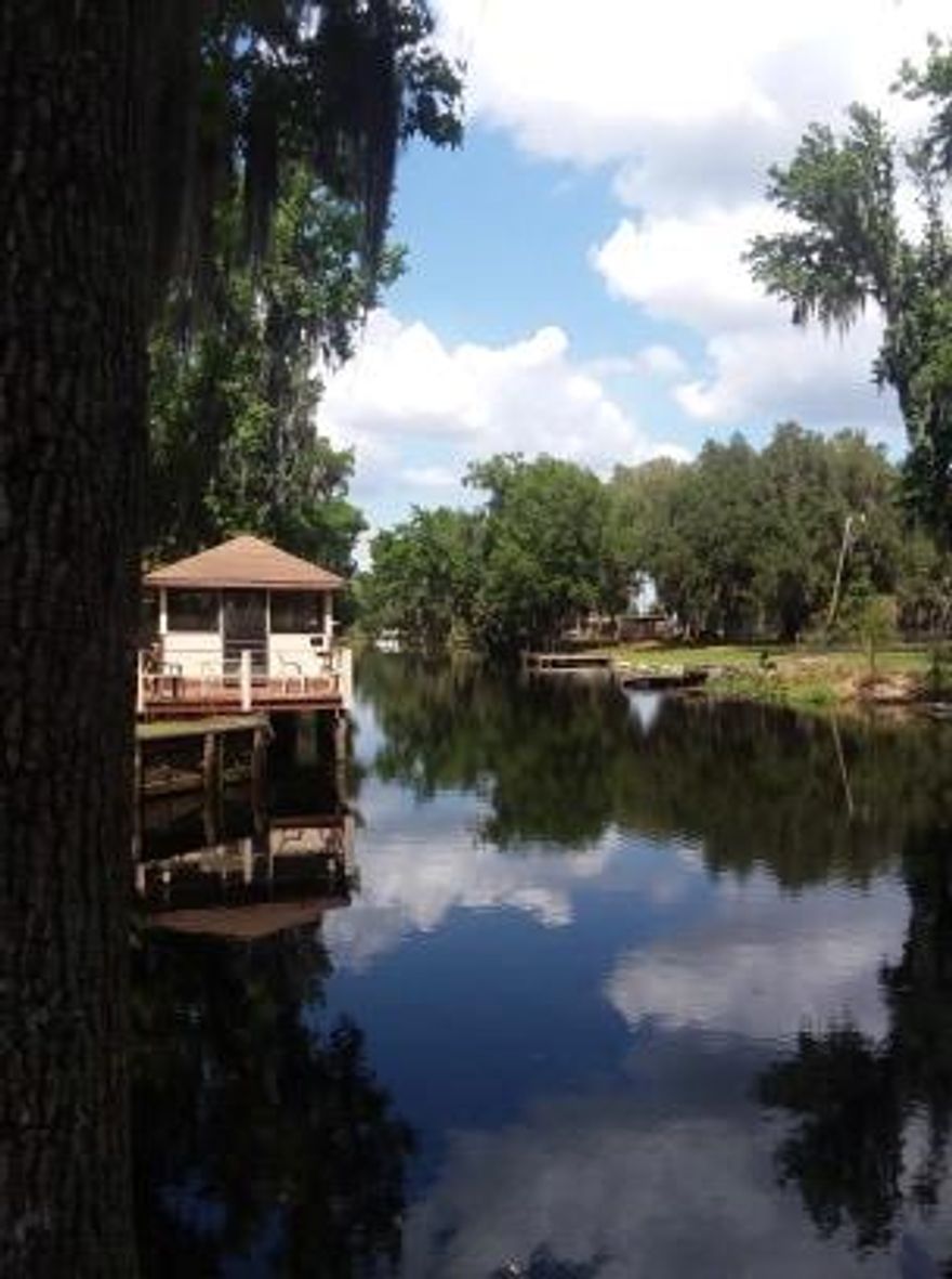 Diamond in the rough.  Could  become a fantastic fish camp or remain a simple income property. Currently has 2 single manufactured homes on property and one CBS studio home.(Additional 2 concrete pads unused)   NEW drain field being installed and CBS home undergoing renovation . Lets discuss offers.