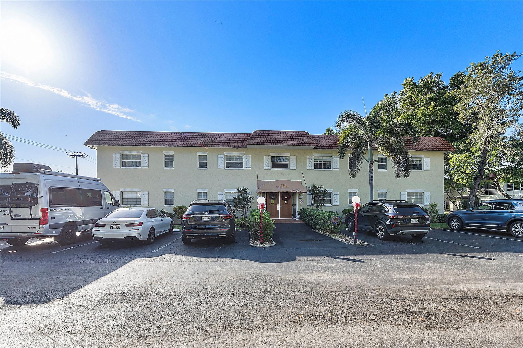 Fully furnished 2/2 corner unit with a peaceful garden view. The unit features tile flooring throughout, refrigerator and range replaced last year, a new water heater, and an updated electric panel. The enclosed Florida room adds extra comfort and tranquility. Located in a well-maintained community offering amenities such as a pool, tennis courts, shuffleboard, a BBQ area, and washer/dryer usage included in the monthly fees. Conveniently close to shopping, restaurants, grocery stores, and transportation. The building has successfully completed its 50-year inspection.