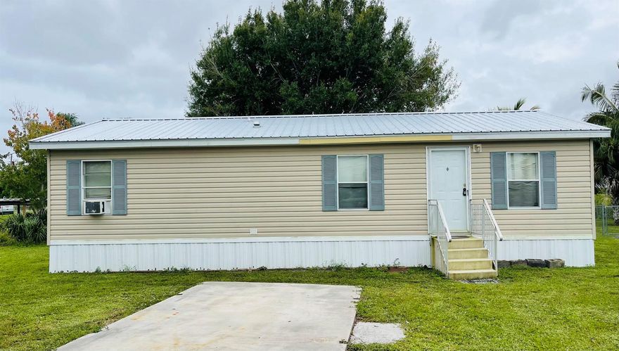 Welcome to your serene slice of Florida paradise! Nestled along a peaceful canal with direct access to Lake Okeechobee, this 2-bedroom, 2-bathroom home offers the perfect blend of comfort, charm, and outdoor adventure. Built in 2005 and situated on an 8,364 sq ft lot, this 1,012 sq ft home is ideal for anglers, nature lovers, or anyone seeking a tranquil escape.Step inside to discover an open-living area bathed in natural light, creating a warm and inviting atmosphere with new laminate floors throughout. The home also has a 2023 metal roof.  Schedule your showing today!