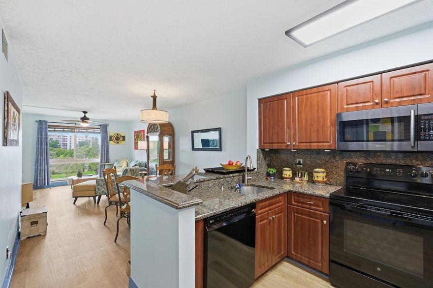 Enjoy SPECTACULAR TROPICAL WATERFRONT Views from this Handsomely Updated, Move-In Ready Unit! Gorgeous, Contemporary Wood Finish Floors in Living Area. Washer/Dryer. Hurricane Impact Windows. No Popcorn. Open Kitchen w/Granite Counters & Backsplash. Split Bedrooms for Privacy. Lakefront Owner's Suite has Ensuite Bath w/Step-In Shower & Walk-In Closet. Spacious Guest Room has Adjacent Guest Bath w/Tub. Pull Up a Chair & Enjoy the Sea Breezes from Your Front Catwalk (NO BALCONY IN UNIT). Resort Style Amenities Are Right Downstairs. Convenient Parking by Elevator & Stairs + Guest Pkg. Heated Pool, Tennis, Jog Trails, Gym, Sauna, Clubhouse, Bird Sanctuary. By TopGolf, Shops/Dining. 12 Min to Beach or Wilton Manors. 2 Pet <25#. 20% Down, Must Own 3 Yrs Before Leasing. Lowest HOA Fee in Area!!!