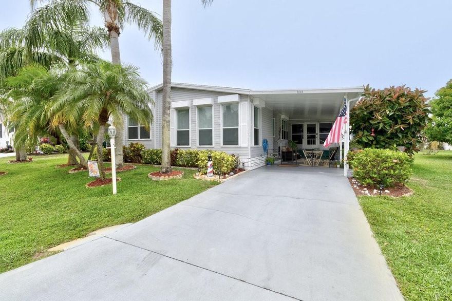 Home for the Holidays! Yes, this could be your new Florida getaway, it's move-in ready on an XL 72x100 lot INCLUDED/NO Lot Rent! Nearly 2,000sf under air including an enclosed patio(176sf) to the Home (1777sf). Large Open Bright kitchen w/ coffee bar, huge master suite w/ double sinks & walk-in shower. Inside laundry (W/D incl), shed/workshop w/sink. Hurricane-ready w/roll-down shutters. Updates: 2022 A/C, 2023 plumbing, fresh 2024 paint. Outside enjoy the lush tropical landscape & lawn with IRRIGATION WELL & Pump with Automatic timer. Conveniently located across from clubhouse. Don't miss it!