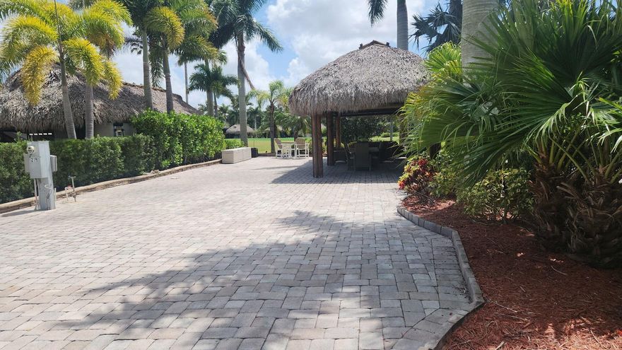 Lot was just power washed - waiting for you! Motorcoach Resort St Lucie West - a Class A only resort, Golf course and water fall views!  Large tiki with electronic shades.  This is a pull in lot to soak up the view!  Pavers add to the enhancement, Modular kitchen unit in place or add your own custom kitchen!  Furnishings included.  Resort amenities in this gated community include - pools, hot tubs, tennis, pickleball, gyn, clubhouse, dog parks, and 3 par 18 hole golf to name a few!  Near shops, restaurants, highways and the NY Mets training facility.