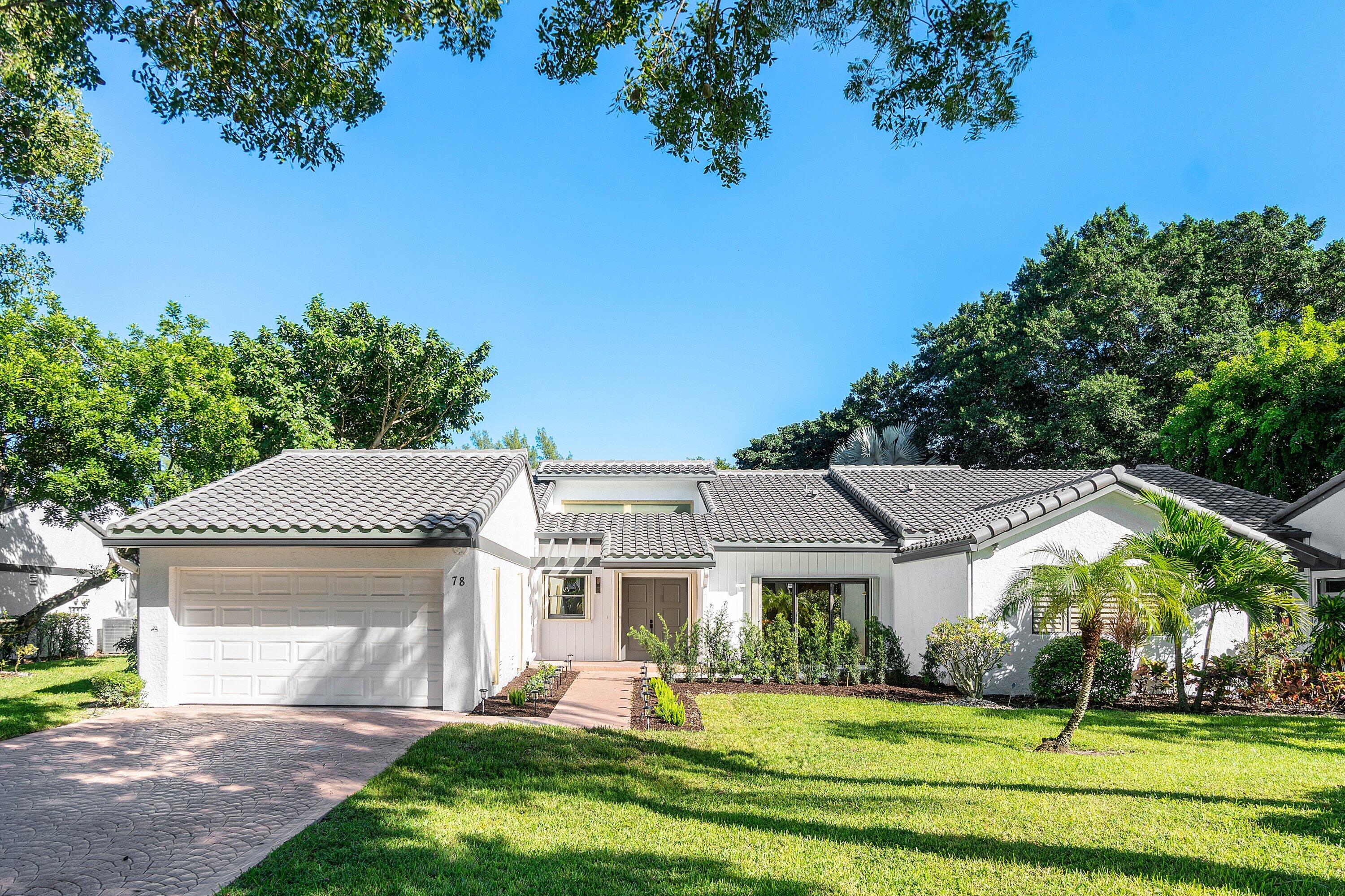 Photos virtually staged. Rare opportunity to own a completely remodeled, 3-bedroom villa in Hampshire at Hunters Run Country Club. This stunning semi-detached residence offers the perfect blend of comfort and luxury. This spacious home boasts 3 true bedrooms, 2 full baths, and a glass-enclosed Florida room across 2,494 square feet of living space. As you step inside, you'll be greeted by an open and airy layout featuring vaulted ceilings, large-format porcelain tile flooring, a contemporary open concept kitchen with stainless steel appliances, a split bedroom layout with a large primary suite with a beautiful spa-inspired bathroom featuring a dual European shower. Two guest bedrooms provide space for hosting your family, with a flex room ideal for a media den setup or home office.