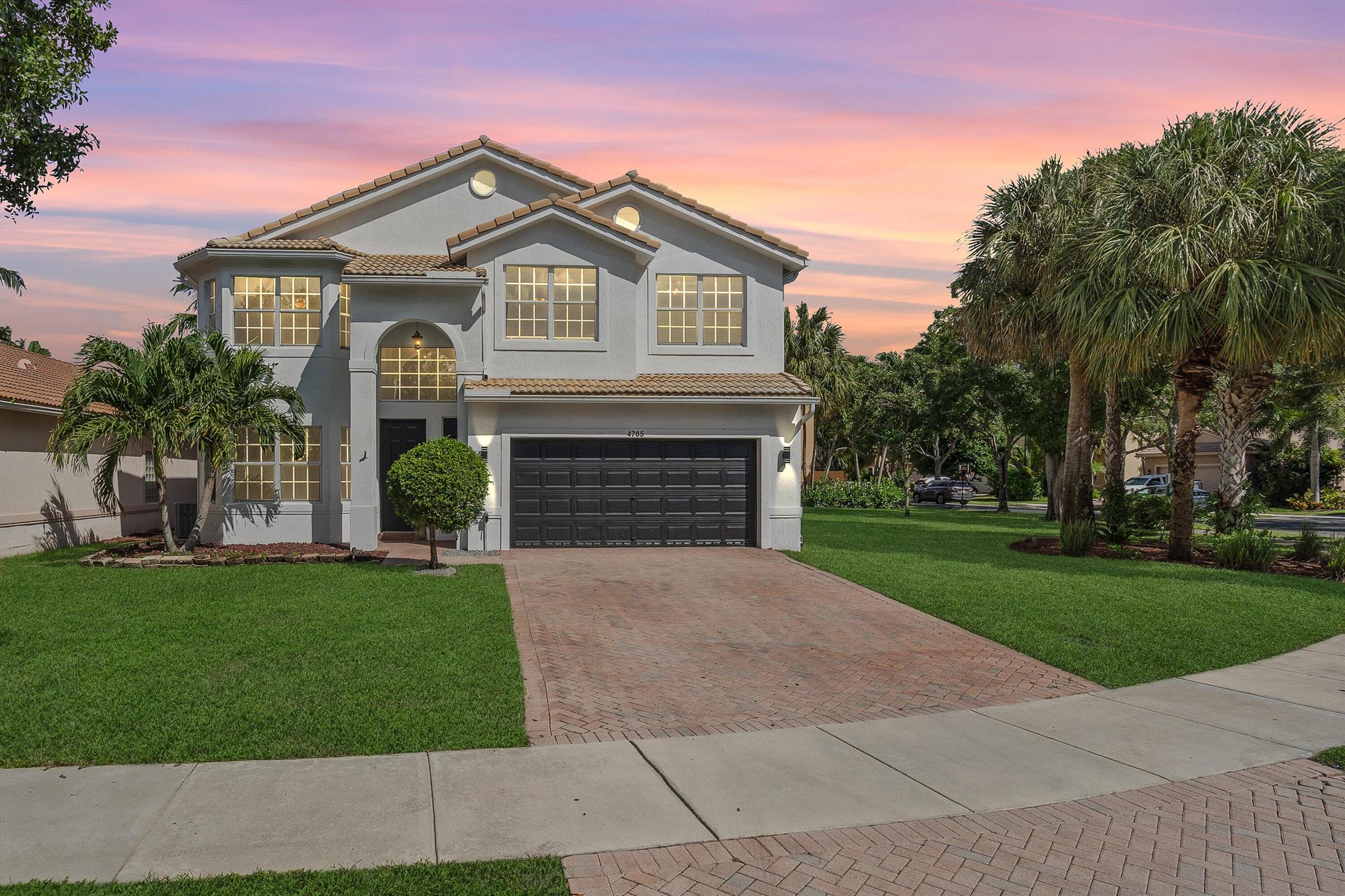 Stunning 2 story corner lot home in The Colony! Boasting ~3K ft of living space, soaring volume ceilings, and a first-floor bedroom or office with half bath, this move-in ready home features updated kitchen & appliances, fresh interior/exterior paint, new flooring, landscaping, 2 new ACs, new water heater, and a garage EV charger. Roof in perfect condition. Enjoy gated community living with resort-style pool, fitness center, and playground. Perfectly located just 4 miles from Delray Beach, close to downtown restaurants, nightlife, and shopping. Low HOA, this home combines luxury, convenience, and lifestyle in one.