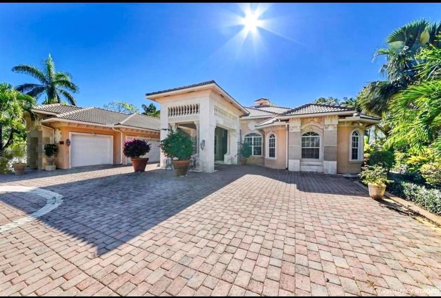 Don't miss out on this one of a kind custom built home situated on 2.46 acres located on a paved road. You will not find another home like this out in the Acreage.  Upgrades galore throughout!  Custom gourmet kitchen, built in wall units, custom bar for entertaining, beautiful marble flooring, custom columns, gorgeous wood carved ceilings & so much more! This 4 bed/4.1 bath home has all the tranquility of living in the country but only minutes to shopping, restaurants & the beach.  Step outside to your own oasis and enjoy your in ground pool & jacuzzi with lush landscaping & fruit trees all around.  This home has not only a 3 car attached garage, there is also a 2 car detached garage that can be used as a workshop.  NO HOA, Bring your RV, Boat, horses & enjoy country living at it's finest!