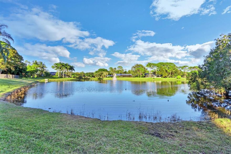 Come home to Whispering Trails ...Unique non gated community  featuring 3 lakes and 181 custom individually designed homes situated on 100 acres in sought after Jupiter...This rarely available 3,128 sq.ft. 5 bedroom, 3 full bath, CBS home ( with steel reinforcing ) sits on a .54 acre lot with a very functional floorplan with the master bedroom conveniently located on the 1st floor and all 4 additional bedrooms with large walk in closets on the 2nd floor...... 1st floor has luxurious vinyl plank flooring with master bedroom and second floor carpeted new in 2018. The remodeled kitchen features granite counter tops and stainless steel Kitchen Aid appliances. A large family room with pine ceiling and a wood burning fireplace leads to a huge screened patio which looks out on a gorgeous rare long lake view and fountain. All 3 A.C. units were fully replaced in 2018 and the pool was refinished and refitted with a new pump, heater, salt water system and new Travertine pool deck in 2020....The property is partially fenced with new fencing installed in 2020. The screened patio and garage both feature high quality epoxy flooring and the garage door is hurricane rated. Whispering Trails has recently been fitted for city sewer service and owner has paid connection and installation charges. This unique and beautiful home is priced to sell today !