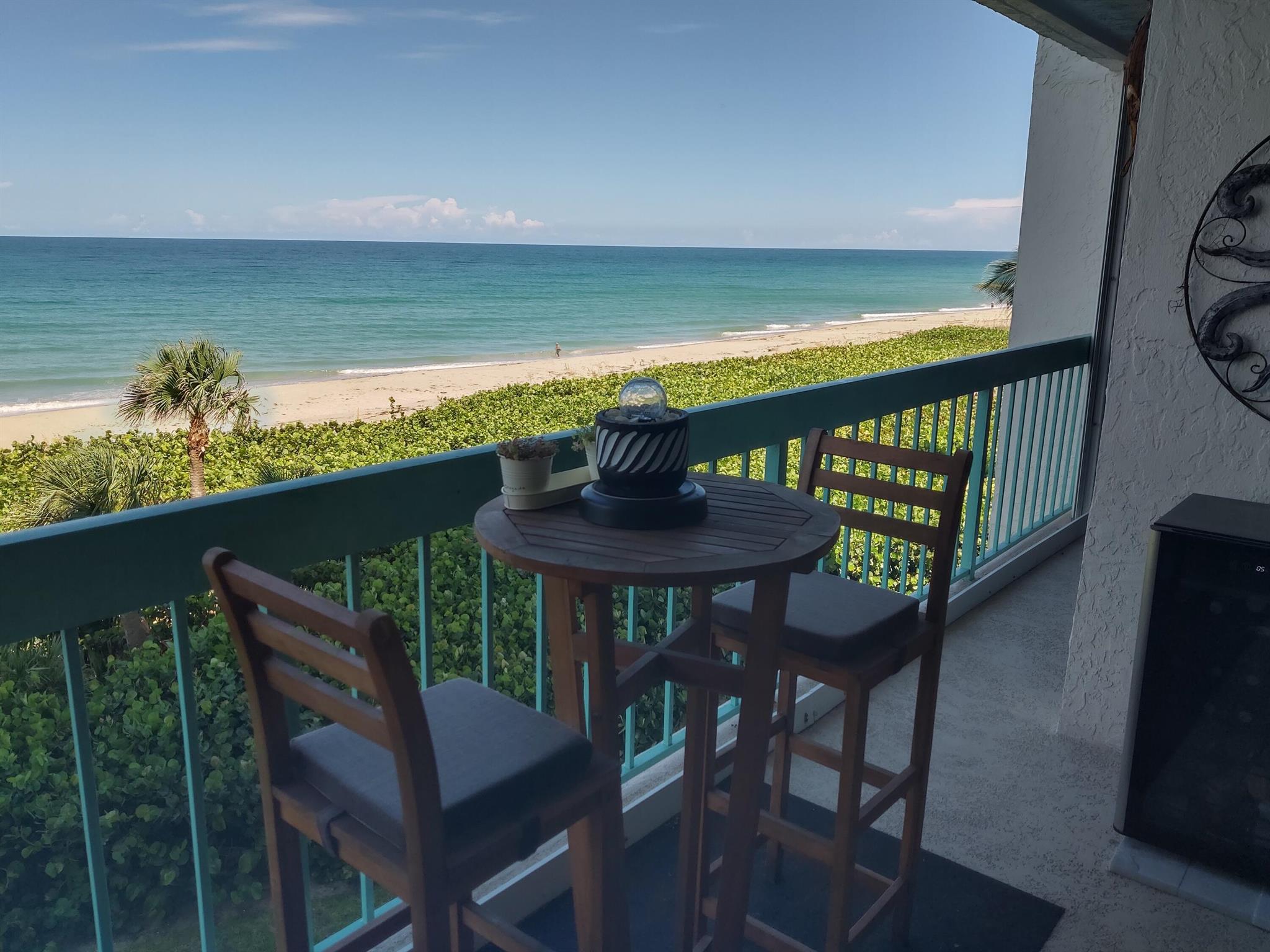 Wake up every morning to the soothing sound of waves and end each day with a breathtaking sunset over the Atlantic. Located directly on the ocean's edge in the prestigious, gated community of Oceana North, this fully furnished, turnkey residence offers a rare opportunity to experience luxury coastal living from the moment you arrive. Floor-to-ceiling views welcome you with electric window shades that reveal sweeping vistas of the ocean from the living room and primary bedroom balconies, while the guest suite provides tranquil views of the intracoastal waterway. Perfect for hosting or relaxing in privacy. Just steps from your door lies immediate beach access, allowing you to walk barefoot to the shoreline in seconds.