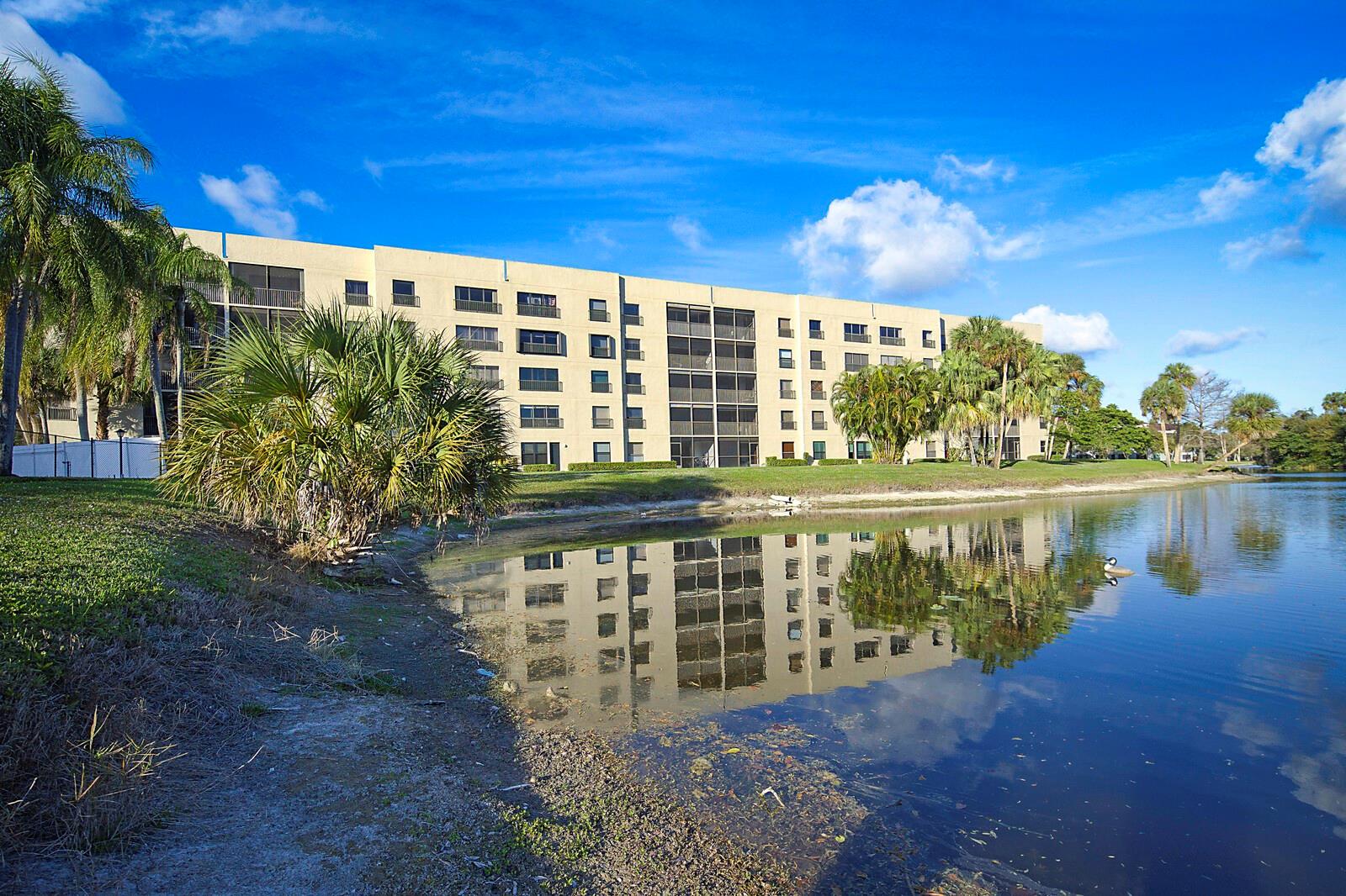 Enjoy beautiful water views from this 5th-floor, 2-bedroom, 2-bath unit in the delightful Tradewinds community. This spacious unit features newer hurricane impact windows, a washer and dryer in the unit, laminate floors throughout, and a gorgeous view of the nature preserve just across the lake. The community is safe, well-maintained, and current with all updated condo requirements, even qualifying for VA financing. The community offers a pool and clubhouse, as well as main facilities that include a large pool, hot tub, gym, library, ballroom, volleyball, and basketball courts.