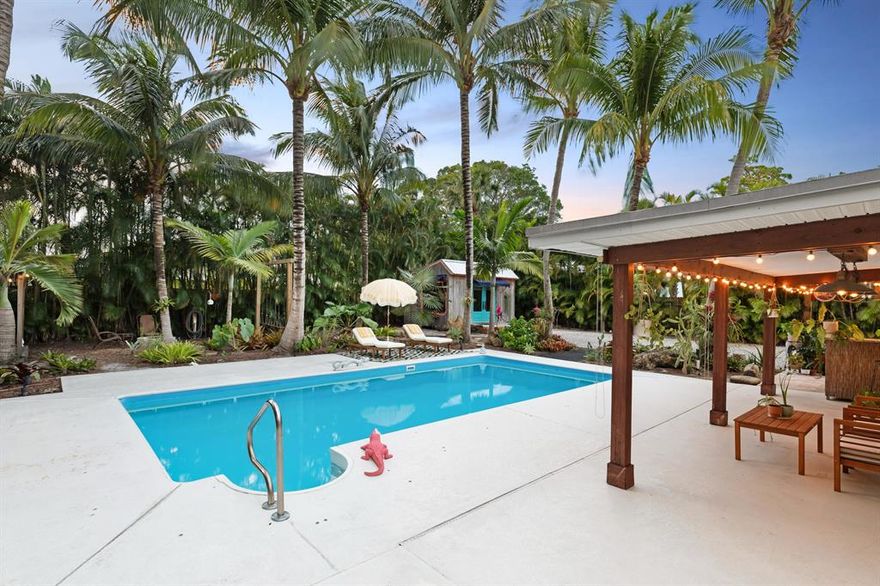 This home is a total mid century charmer with 3 bedrooms and 2 bathrooms  settled on over a 1/3 an acre in the heart of downtown stuart. There are so many details that take this property to the next level.  Some include the beautiful wood detailing throughout, a rounded wood slatted wall that leads to the bedrooms, an air conditioned garage with matting for the perfect multipurpose space, extra gas hookups near the outdoor kitchen for BBQs, a fully outfitted garden, and whole house speakers throughout the home and backyard. The list goes on and on. Both bathrooms have been beautifully updated and feature tall ceilings with a skylight, and ornate detailing.  Every inch of this home has something special.  The real star of the show is the property Itself.  The double lot features a larg yard for all your toys, an RV hook up, a heated salt water pool, summer kitchen for all your entertaining needs, and two outdoor sheds/studio spaces. Both have electric running to them, one 220 plug, and the other with plumbing connected. A favorite feature is the campsite swings and the outdoor shower all within the immaculate backyard paradise. If you do decide to venture outside your slice of heaven, explore all that downtown Stuart has to offer: amazing restaurants, shopping, coffee shops and more. Check out the beautiful waterways located blocks away or take a quick drive to the beach.  Live like you're always on vacation at 418 se Alamanda way.