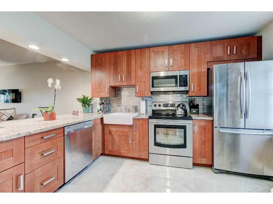 WOW! Stunning renovated condo w/ brand new stainless steel Samsung high efficiency appliances & much more. Wood floors,  glass enclosed showers, modern high end finished through out. NEW A/C installed 9/15/2015. Hurricane impact glass enclosed patio doors  creating extra living space. Open concept kitchen to living. 2nd floor unit with no one above you! Great for all year or snow birds. Live in the heart of Boca Raton! Gorgeous golf course views without the mandatory membership 55+. Community POOL!