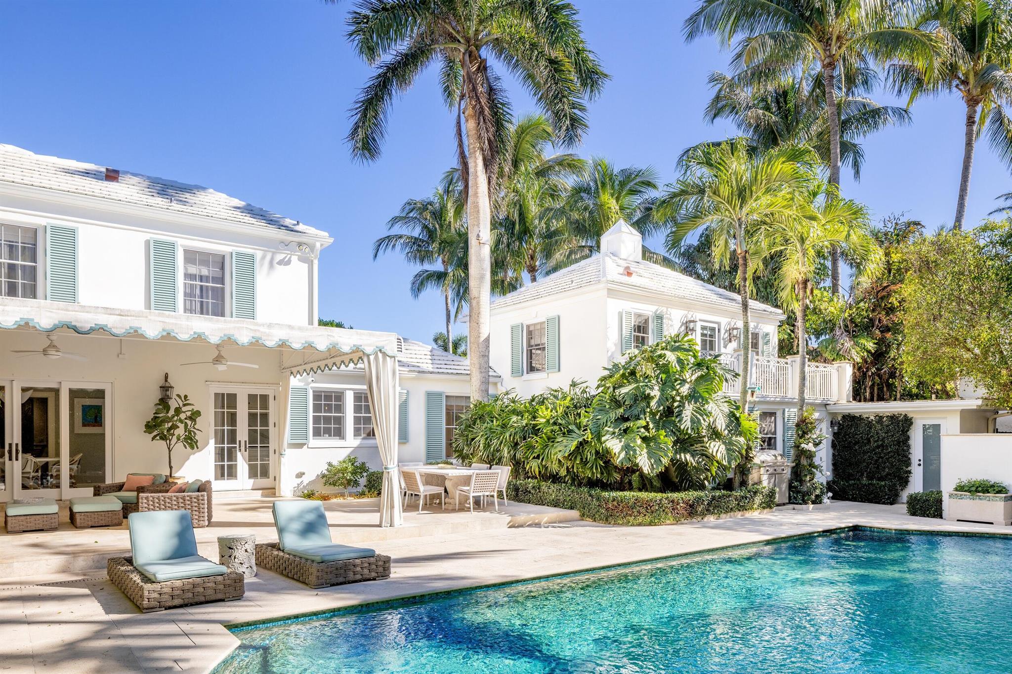 Gorgeously remodeled Monterey Colonial home designed by renowned Palm Beach architect John Volk. 6 bedrooms, 7 full baths, and powder room. Situated on a 14,500 +/- square foot lot, this home features over 7,000 total square feet, formal living room, and beautiful dining room. Formal entryway and large gallery hall. Oversized interior loggia leading to gourmet eat-in chef's kitchen and breakfast room. Iconic John Volk staircase leads to second floor den with Juliet Balcony. Expansive primary suite features gorgeous bath with stunning marble floors and details. Beautiful and serene landscaping surrounds large pool and covered patio. Gracious entry approach and parking with circular drive and driveway leading to 2 car air-conditioned garage. Guest apartment with terrace overlooking pool.