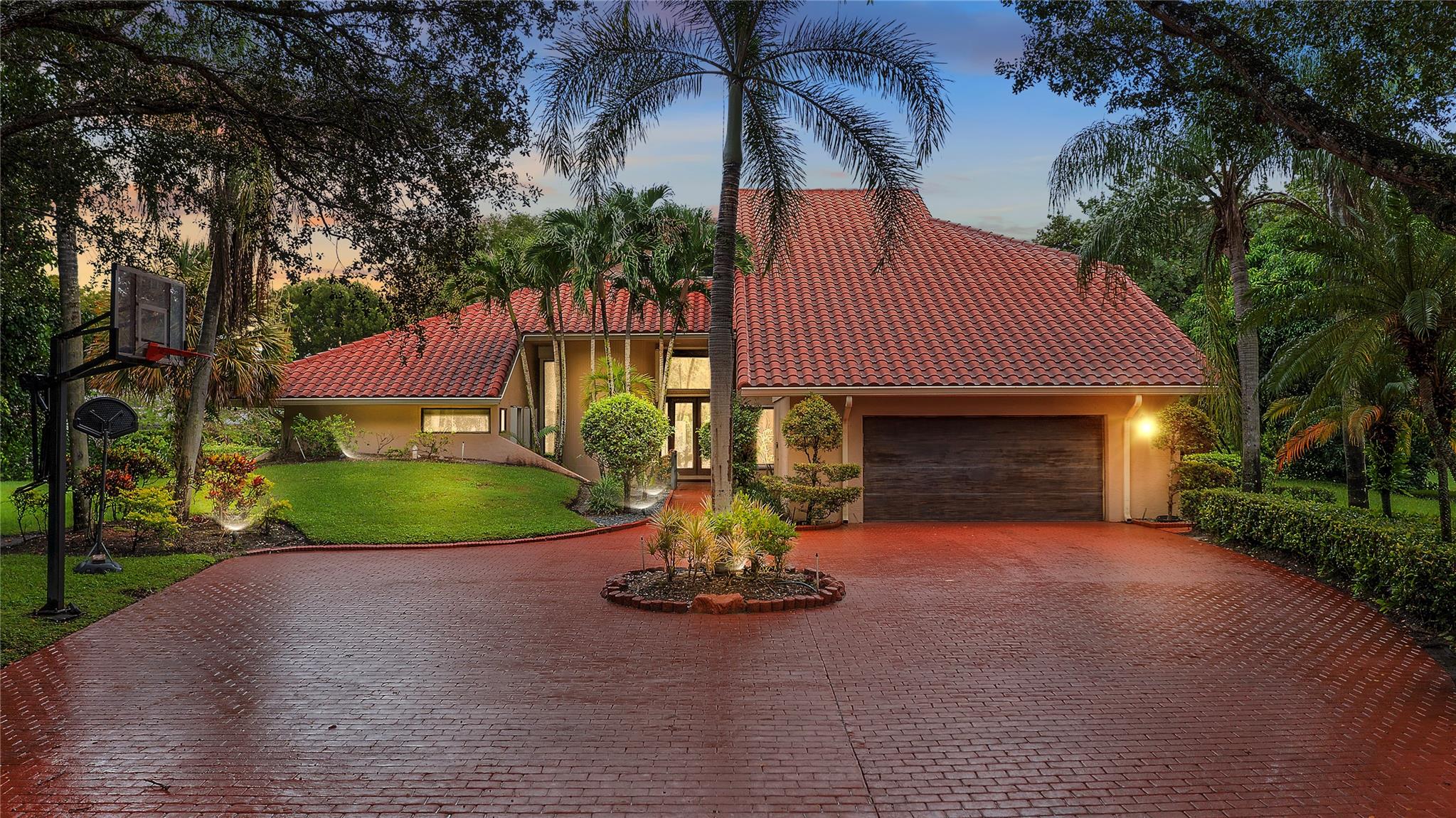 Welcome to this one-of-a-kind estate in the exclusive gated community of Maplewood Isle. Situated on a cul-de-sac and on the point of the lake, this impressive residence offers 4,973 sq ft of living space on just under a half-acre lot. Featuring 5 spacious bedrooms, a private office, and a versatile bonus room, this home is designed for both comfort and functionality. A highlight of the property is the separate guest quarters with its own private entrance, ideal for extended family or visitors. Indulge in the luxury of your own private sauna or enjoy the Florida lifestyle in the expansive backyard with a sparkling pool and breathtaking lake views. With its rare combination of space, privacy, and amenities, this home is truly a remarkable opportunity in Maplewood Isle. Don't miss this one!