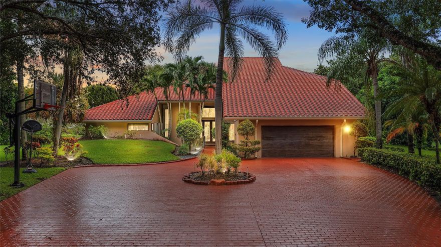 Welcome to this one-of-a-kind estate in the exclusive gated community of Maplewood Isle. Situated on a cul-de-sac and on the point of the lake, this impressive residence offers 4,973 sq ft of living space on just under a half-acre lot. Featuring 5 spacious bedrooms, a private office, and a versatile bonus room, this home is designed for both comfort and functionality. A highlight of the property is the separate guest quarters with its own private entrance, ideal for extended family or visitors. Indulge in the luxury of your own private sauna or enjoy the Florida lifestyle in the expansive backyard with a sparkling pool and breathtaking lake views. With its rare combination of space, privacy, and amenities, this home is truly a remarkable opportunity in Maplewood Isle. Don't miss this one!