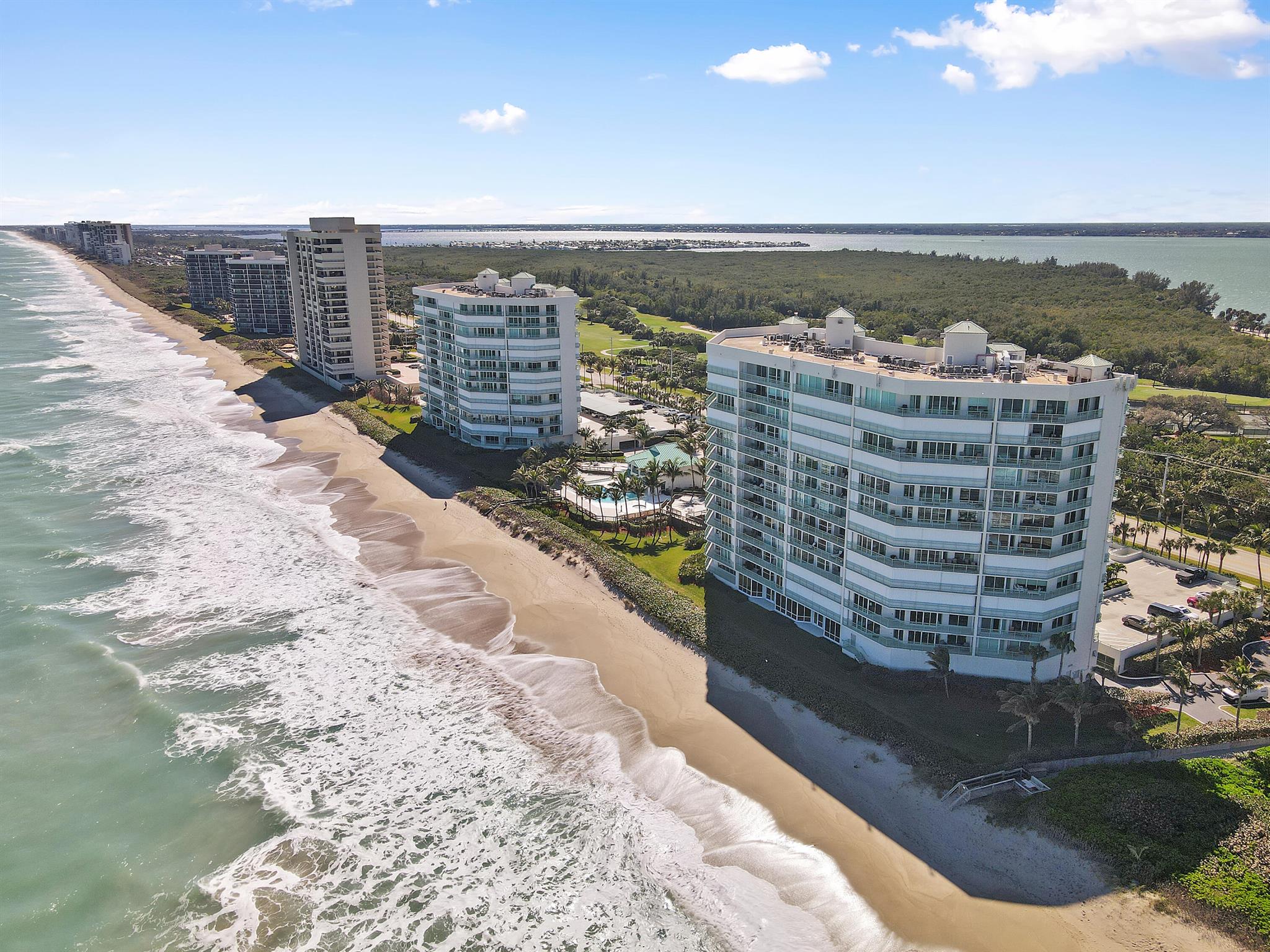 Welcome to Regency Island Dunes, one of Hutchinson Island's premier beachfront communities! This stunning rental offers breathtaking ocean and intercoastal views alongside resort-style amenities. Step through the French door entry to find nearly floor-to-ceiling windows and doors framing panoramic vistas. The open-concept living space is beautifully furnished with Natuzzi electric couches, while the renovated kitchen allows you to cook and entertain without losing sight of the views. The spacious master suite features adjustable split beds and is split from two additional bedrooms for privacy. As a unique ''through-and-through'' unit, the back bedrooms have their own balcony overlooking the intercoastal. Regency amenities include 24/7 security, a pool/spa, fitness center, clubhouse,
