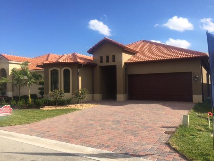 NEW CONSTRUCTION - on the Lake with a spa like pool and upgrades include wood floors in the bedrooms, crown molding, built in appliances, and outside bar where the 1/2 bath is located as well, interior doors are 6'8'' to 8' high, art niches, pantry and such all have crown moldings, stainless steel appliances, diagonal tile throughout living areas and kitchen, nice sized pool with luxurious landscaping. Truly a beautifully constructed home for this price - impact windows are also part of this package.  This community offers the residents so much from desirable schools, to brick paver driveways and nice sidewalks, to allowing larger dogs, trucks are okay as long as they aren't commercial vehicles, and a fantastic location in the heart of Boynton Beach. There is a community pool, tennis courts, and a playground. There are other available lots - two without lake view and one that has a lake view and is also extra large as it is a corner lot. If you haven't taken the time to see this community and the builder's designer touches and attention to detail and quality - you need to make time and see these homes. The builder is on site daily overseeing the details of the construction.  You don't get that attention to quality and detail from large corporations. This is an awesome opportunity to own an executive styled home with significant upgrades and a pool and lake view.