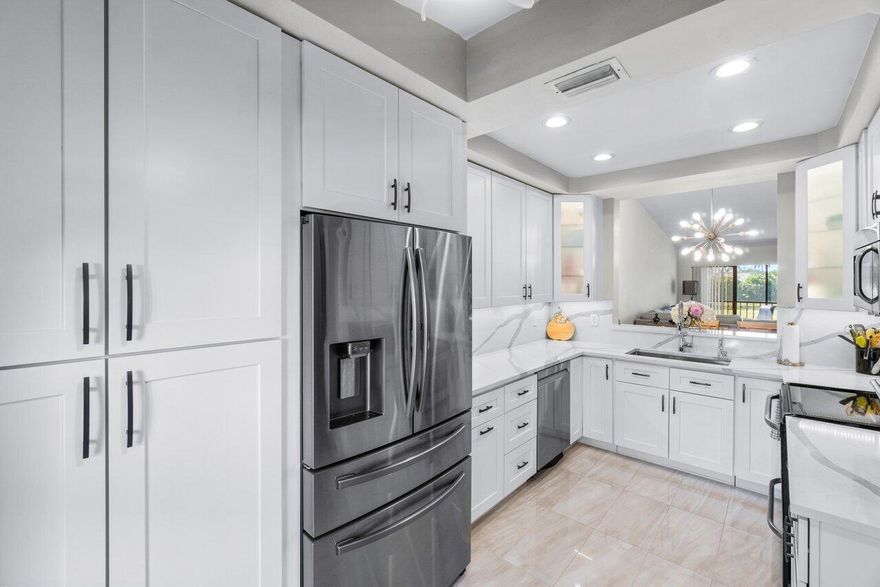 Just bring your toothbrush- this stunning, remodeled home offers the perfect blend of comfort, luxury, and convenience. With picturesque golf and water views, a spacious open layout, and top-tier finishes throughout, it's ideal for those seeking both relaxation, style and convenience! Enjoy cooking in your brand-new, fully upgraded kitchen, featuring a cozy coffee bar, sleek quartz countertops, 42'' soft-close cabinets, including a large pantry with pullouts, and a premium appliance package. The elegant laminate flooring extends throughout the home, complemented by vaulted ceilings and two balconies perfect for entertaining or simply unwinding. Both bathrooms have been renovated with modern touches, while the laundry room boasts a newer washer and dryer.