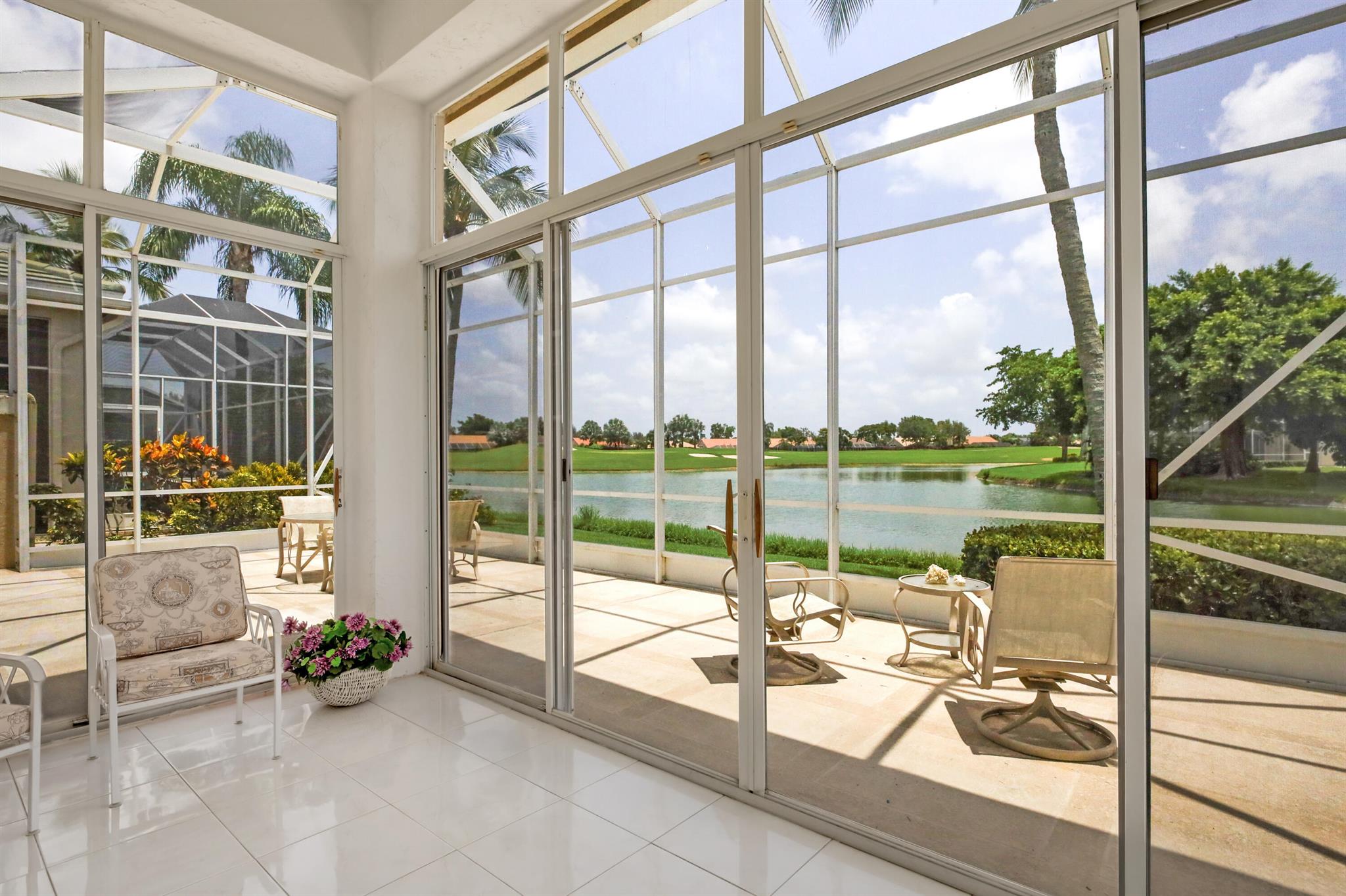Nestled in a picturesque lakeside setting with tranquil views of both the lake and the golf course, this property in the 24/7 manned-gated Aberdeen Country Club community offers an unparalleled lifestyle for all ages without restrictions.Step inside to find a freshly painted, open and airy floor plan featuring soaring 12-foot ceilings and an abundance of natural light. The spacious primary bedroom includes a large ensuite bathroom, a generous walk-in closet, and another reach-in closet with built-in shelving. The home also offers a second bedroom and a versatile den or office. The kitchen has a cozy breakfast area. Additional features include recessed lighting, a 2023 washer and dryer, and a 400-square-foot enclosed lanai that seamlessly blends indoor and outdoor living, perfect for