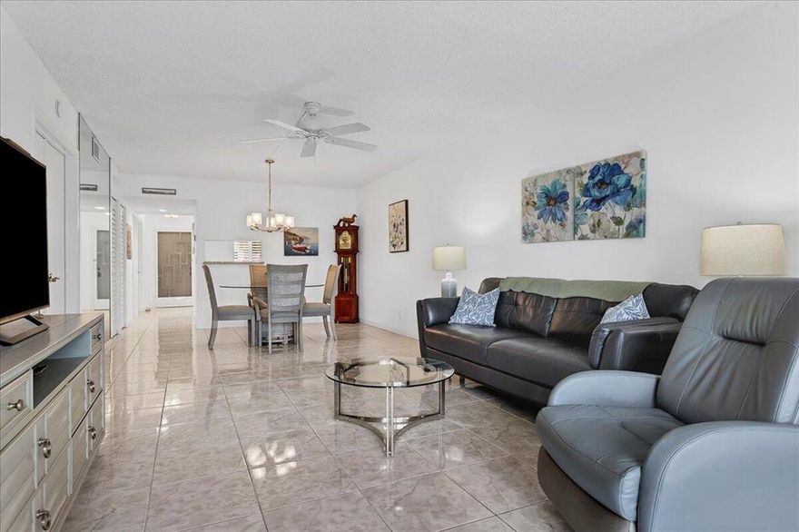 Don't miss this fully remodeled condo in the best location.  Kitchen and baths masterfully remodeled Beautiful tile throughout.  open Lanai with floor to ceiling impact doors overlooking lake and pool make for more living space and wonderful views.  Gorgeous kitchen with white cabinetry and granite counters.  Newer AC and Hot water tank.  All this in a community that has it all to keep you active.  pool, tennis, bocce, pickle ball, club house with cafe. weight room, clubs and much more.  Ready for you to move in and start enjoying.