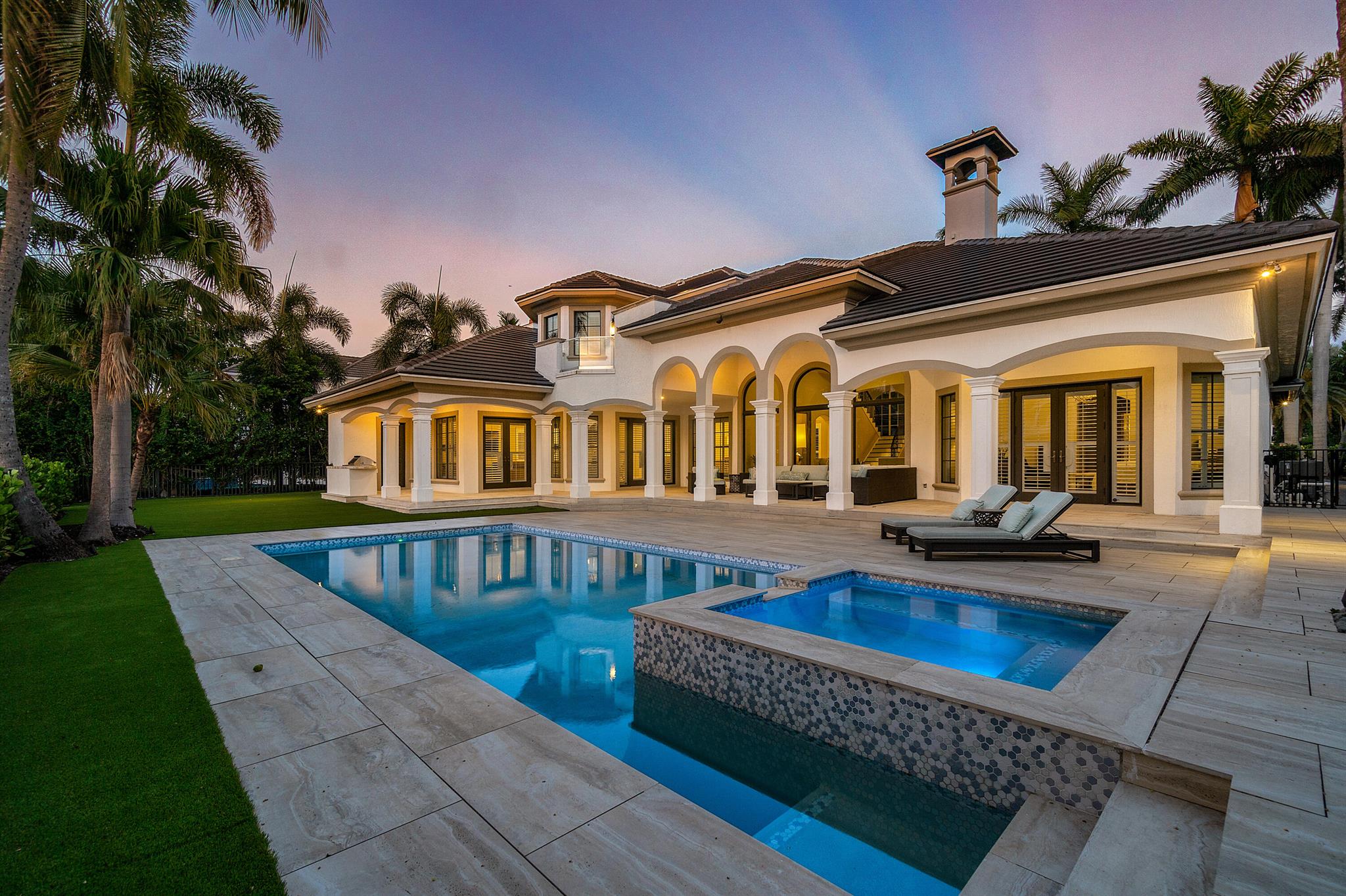 This stunning furnished home in prestigious Royal Palm Yacht club offers a prime location on the golf course with panoramic views. The home has been remodeled with exquisite taste & attention to detail, featuring high ceilings, impact glass windows and doors, and a new roof installed in 2020. The kitchen is a chef's dream with calcutta marble countertops, viking gas stove, sub zero refrigerator and large wine storage. The master suite is on the first floor and features wood flooring and a spa-like bathroom w/ 2 water closets The downstairs also boasts a rich wooden paneled library. Upstairs are 3 ensuite bedrooms and cozy loft,area The backyard is an oasis of relaxation and entertainment, with a large covered loggia, heated pool, spa & summer kitchen