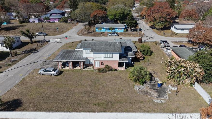 Located in Fort Pierce, this two-story home sits on a spacious corner lot with plenty of potential. The property features a solid brick lower level and a light upper exterior, offering classic character. A covered carport and extended driveway provide ample parking. The large yard is perfect for outdoor living, or future enhancements. With a flexible layout and room to customize into a duplez, in law suite or man cave, this home is ideal for homeowners or investors alike. Conveniently situated near local schools, shopping, dining, and beautiful Treasure Coast beaches.