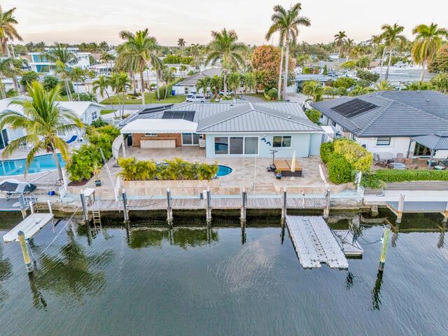 Live the waterfront dream in Pompano Beach's coveted Harbor Village! This beautifully remodeled and expanded (2016) single-story home features Italian porcelain tile, stone countertops, plantation shutters, and a 300 lb/day ice maker. Enjoy energy-efficient upgrades like a natural gas tankless water heater, grill/smoker hookups, and a 50-amp EV-ready circuit. Relax by the solar-heated saltwater pool and hot tub, or on the travertine patio. Boaters will love 75 feet of seawall, floating dock, tide slides, and dolphin piles. Solid core doors, split A/Cs, and upgraded insulation complete this waterfront paradise. A must-see! Seller Financing Available!