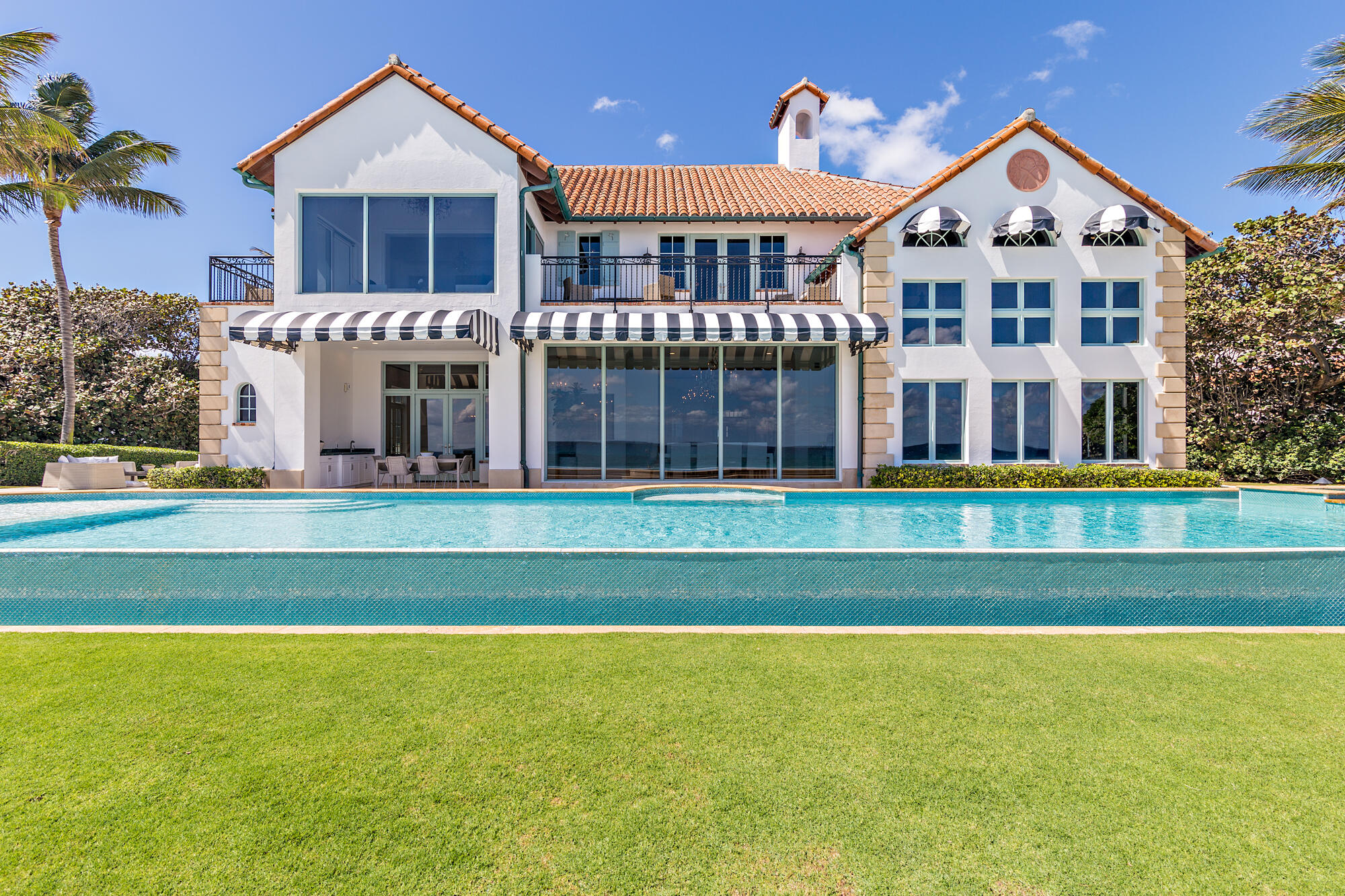 Spectacular seaside paradise recently renovated. Ocean-to-Lake estate with almost 400 feet of depth allowing expansive outdoor space and privacy. Sprawling 150 feet +/- of beach frontage with an infinity pool overlooking the Atlantic Ocean. Breathtaking gardens with outdoor water features, dining area, and oceanfront loggia. This one-of-a-kind custom estate includes 5 bedrooms, 6 full and 1 half bathrooms along with a guest house including full kitchen. An entertainer's dream complete with open living areas, home theater, billiards room, artificial turf with 18-hole golf and tennis court Not only is the residence an incredible offering, but the land and location are second to none.