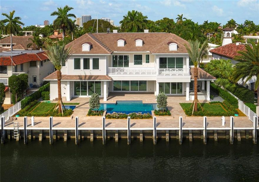 Coastal, soft modern masterpiece.  Impeccably constructed with superior finishes, located on one of the most desirable Isles on Las Olas. Enjoy wide water views from the pool area and second floor balconies.  Library, club room, wine room, 4-car garage, elevator, 48 KW home generator, and oversized guest bedrooms are just some highlights of this ingenious design. Chefs kitchen featuring six burner Wolf range w/griddle, Wolf double wall oven, side by side Sub Zero, Bosch dish washer and pantry. Outdoor summer kitchen/bar with covered logia, Indoor/outdoor sound system and security cameras. 100 feet of waterfront, new seawall and concrete dock with 150 and 100 amp service.