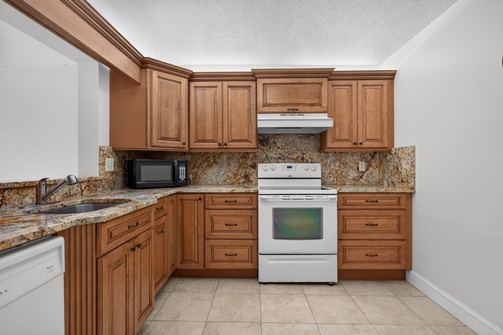 Photo of 2073 CORAL RIDGE Drive #N205, Coral Springs, FL 33071 (MLS # B26089755)